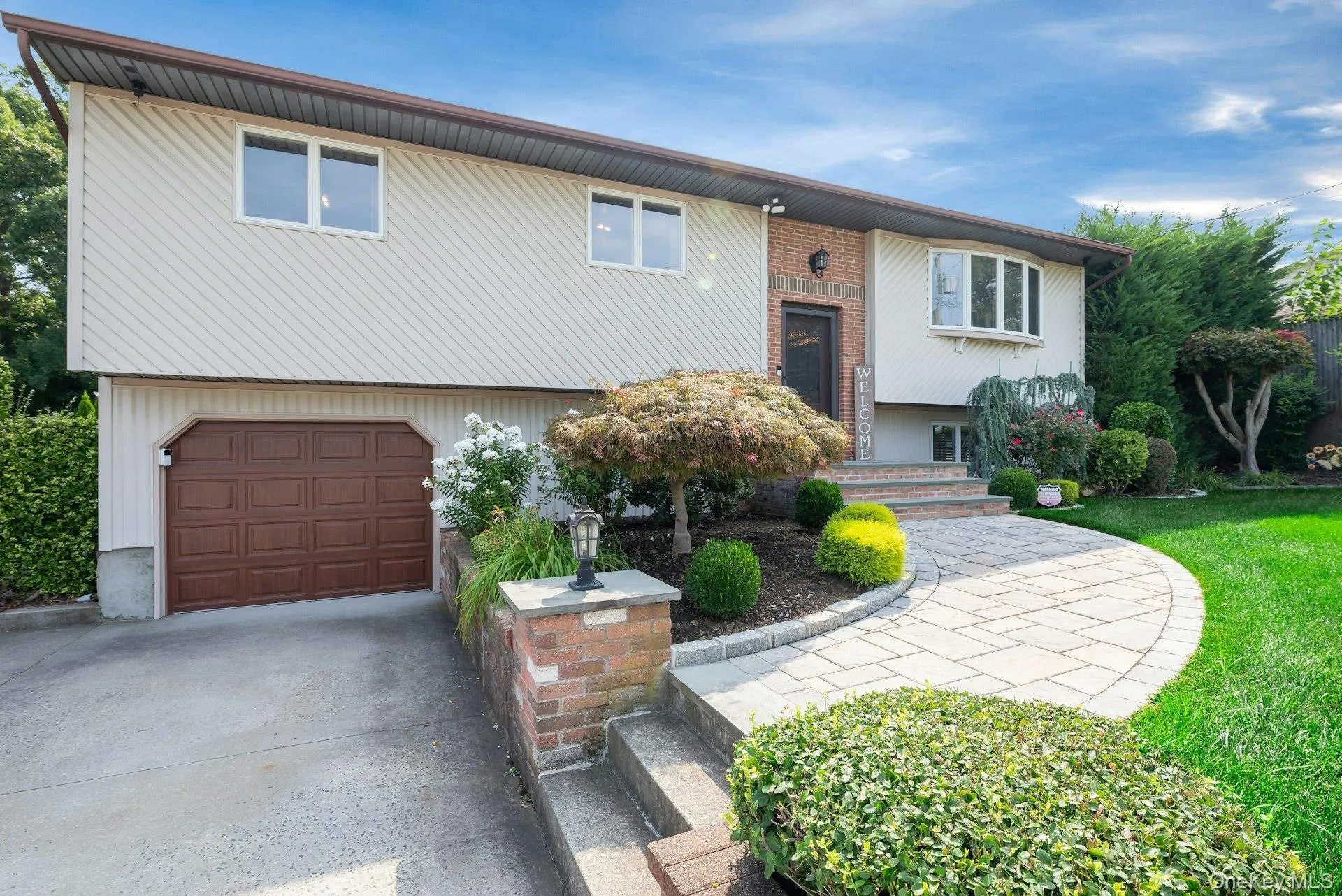 brown panel one care garage door, and a paver walkway brown panel one care garage door, and a paver walkway