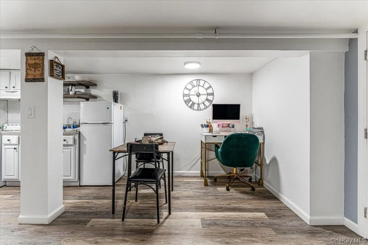 This fully finished basement features durable wood-look flooring, bright white walls, and an open layout that easily accommodates a dining space and a home office nook. This fully finished basement features durable wood-look flooring, bright white walls, and an open layout that easily accommodates a dining space and a home office nook.