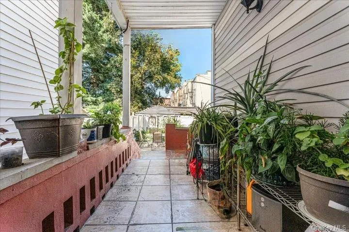 The covered backyard pathway features low-maintenance tiled flooring and plenty of space for potted plants and greenery. It offers a clear, comfortable walkway that guides you directly to the open backyard area. The covered backyard pathway features low-maintenance tiled flooring and plenty of space for potted plants and greenery. It offers a clear, comfortable walkway that guides you directly to the open backyard area.