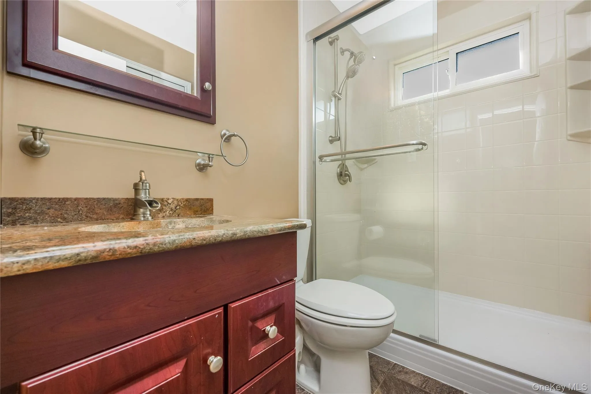 Wood-finish vanity with a stone countertop and an integrated sink Wood-finish vanity with a stone countertop and an integrated sink