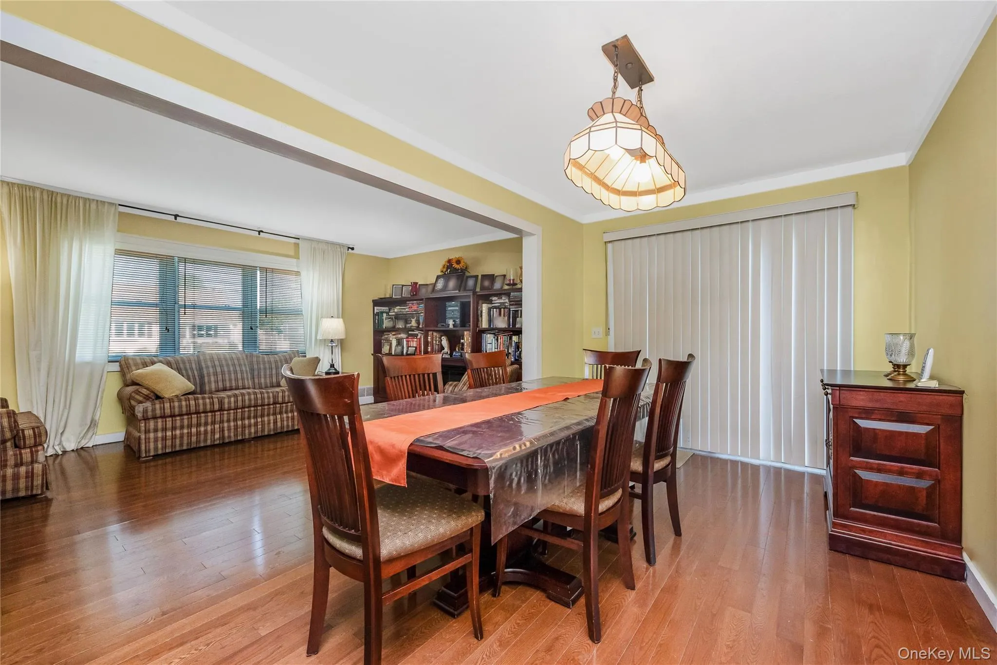Hardwood flooring throughout, crown molding, cased openings, and a built-in bookshelf Hardwood flooring throughout, crown molding, cased openings, and a built-in bookshelf