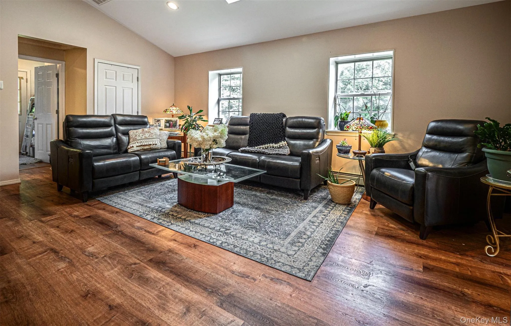Expansive living room with oversize windows & skylight Expansive living room with oversize windows & skylight