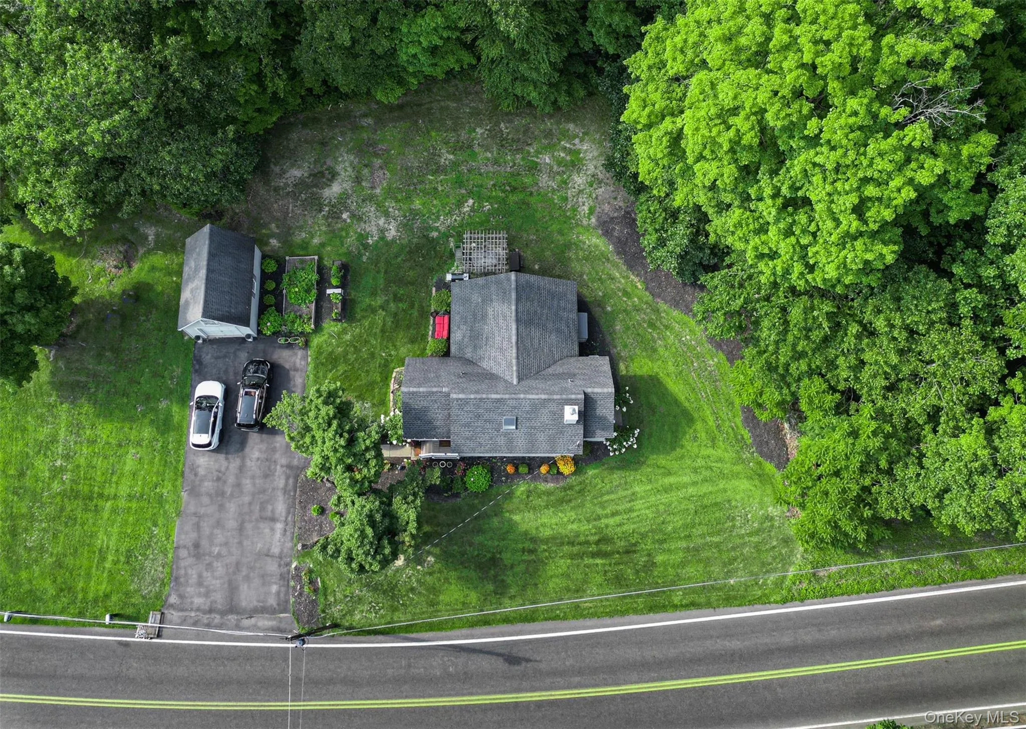 Expansive green lawn, mature perimeter trees, garage & paved driveway Expansive green lawn, mature perimeter trees, garage & paved driveway