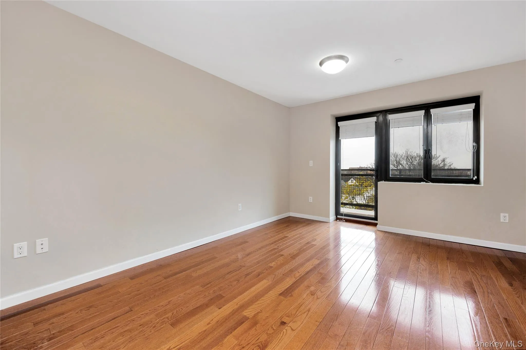 Spare room featuring light wood finished floors and baseboards Spare room featuring light wood finished floors and baseboards