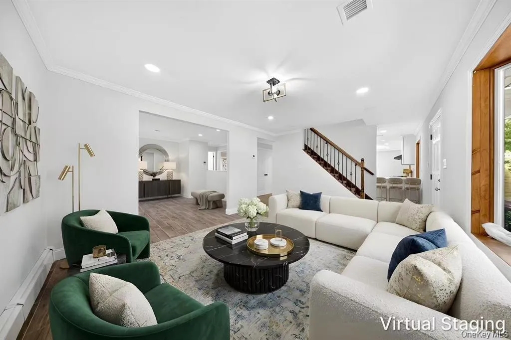 Recessed lighting, crown molding, wood-finish flooring, staircase with wrought iron balusters, and a contemporary ceiling fixture Recessed lighting, crown molding, wood-finish flooring, staircase with wrought iron balusters, and a contemporary ceiling fixture