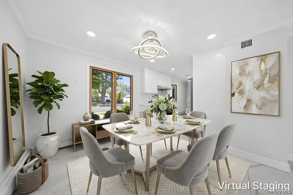 White walls with crown molding, recessed lighting, and a modern chandelier White walls with crown molding, recessed lighting, and a modern chandelier