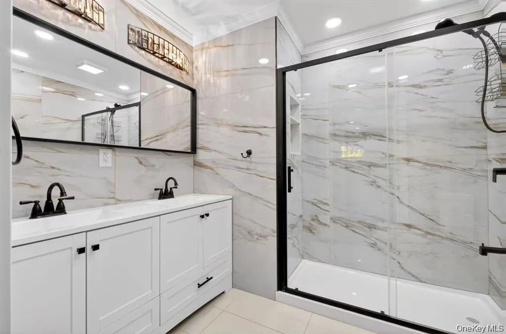 Dual vanity with white cabinetry and solid surface countertop Dual vanity with white cabinetry and solid surface countertop