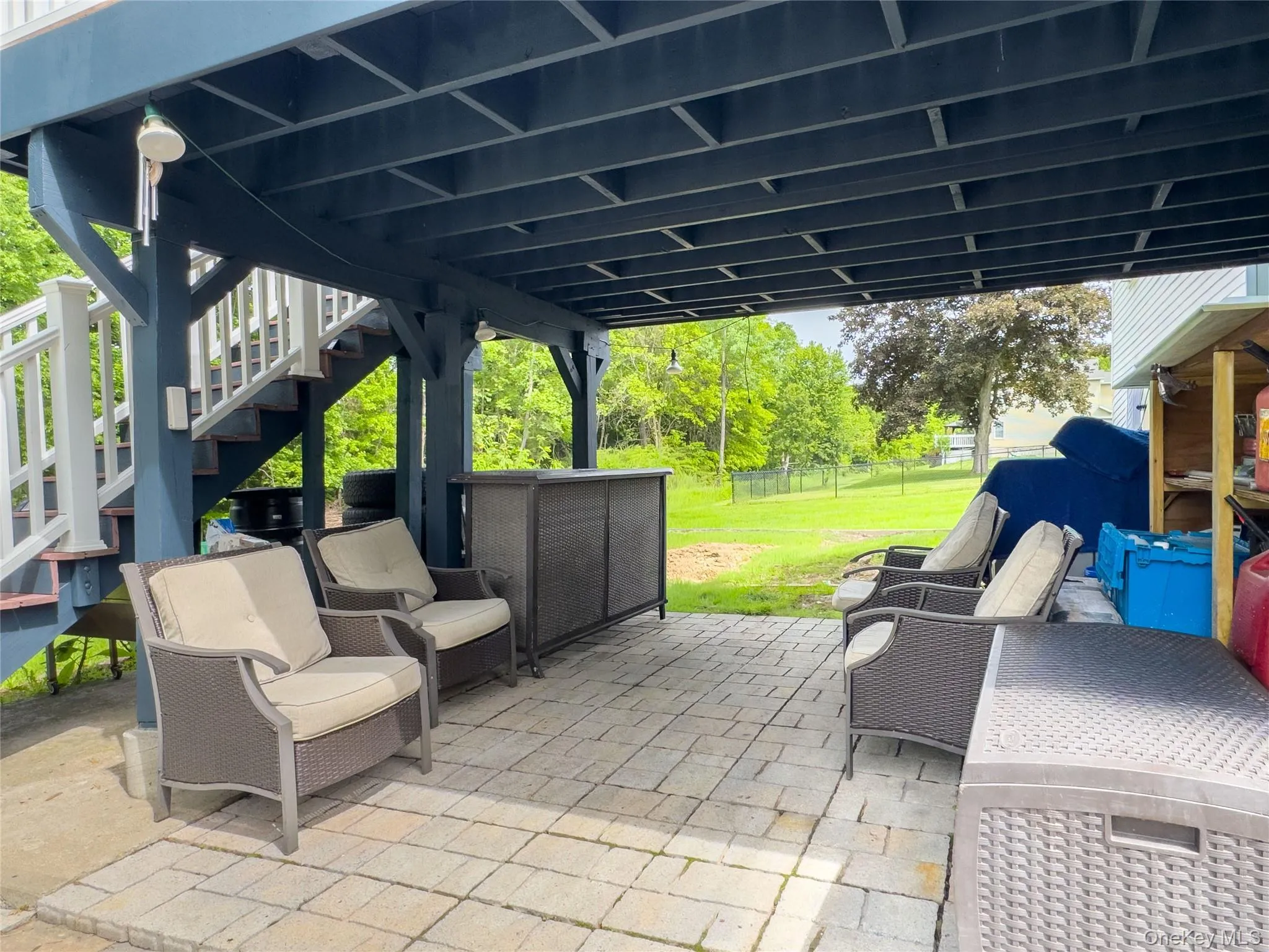Covered patio with paver flooring and a built-in outdoor bar Covered patio with paver flooring and a built-in outdoor bar