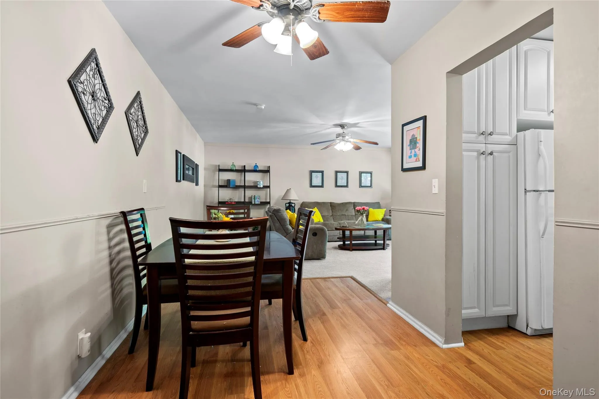 View from the entry hallway, pass the dining room area into the living room View from the entry hallway, pass the dining room area into the living room