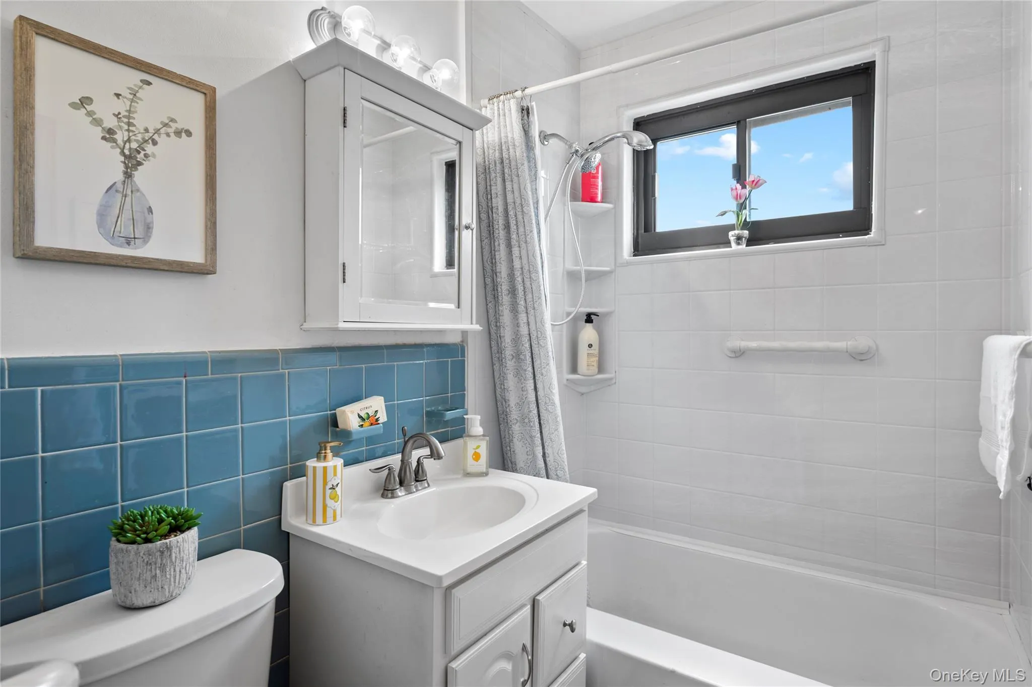Bathroom with white bathtub & shower, vanity Bathroom with white bathtub & shower, vanity