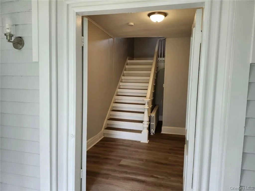Staircase/Atrium area with wood-type flooring, leading to entrance foyer. Staircase/Atrium area with wood-type flooring, leading to entrance foyer.