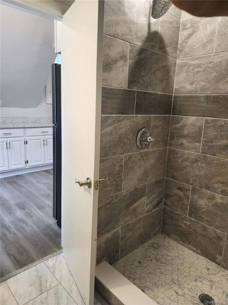 Bathroom featuring a custom tile shower with Pedestal Sink Bathroom featuring a custom tile shower with Pedestal Sink