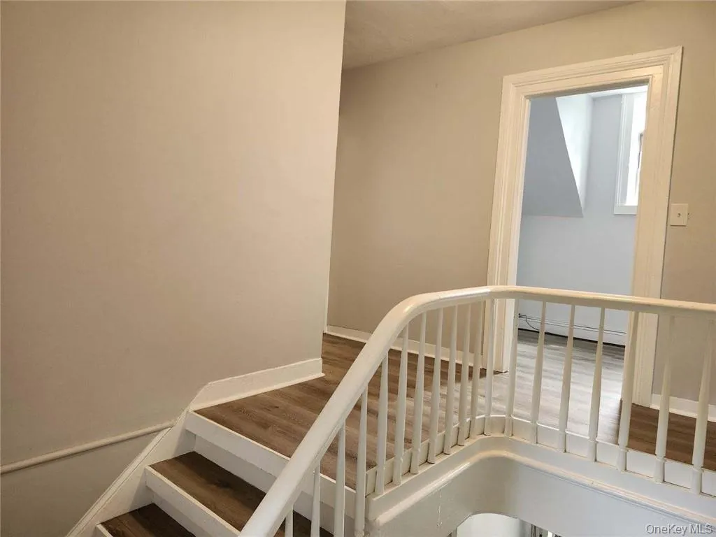 Stairway featuring hardwood / wood-style floors Stairway featuring hardwood / wood-style floors