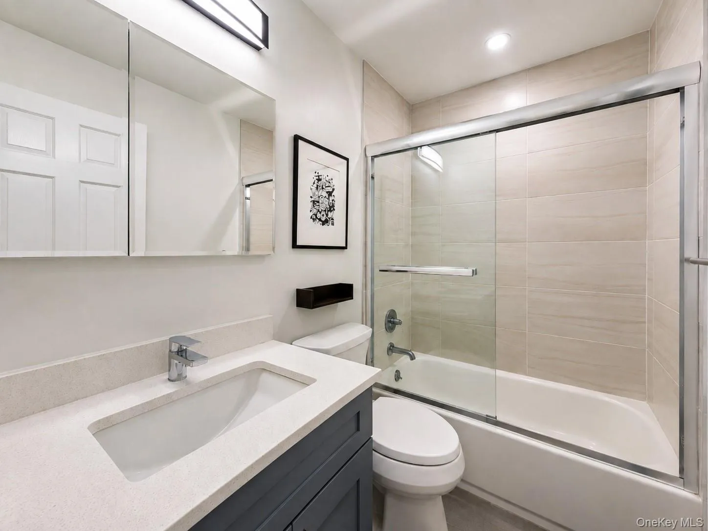Integrated vanity with an undermount sink, chrome faucet, and quartz countertop Integrated vanity with an undermount sink, chrome faucet, and quartz countertop