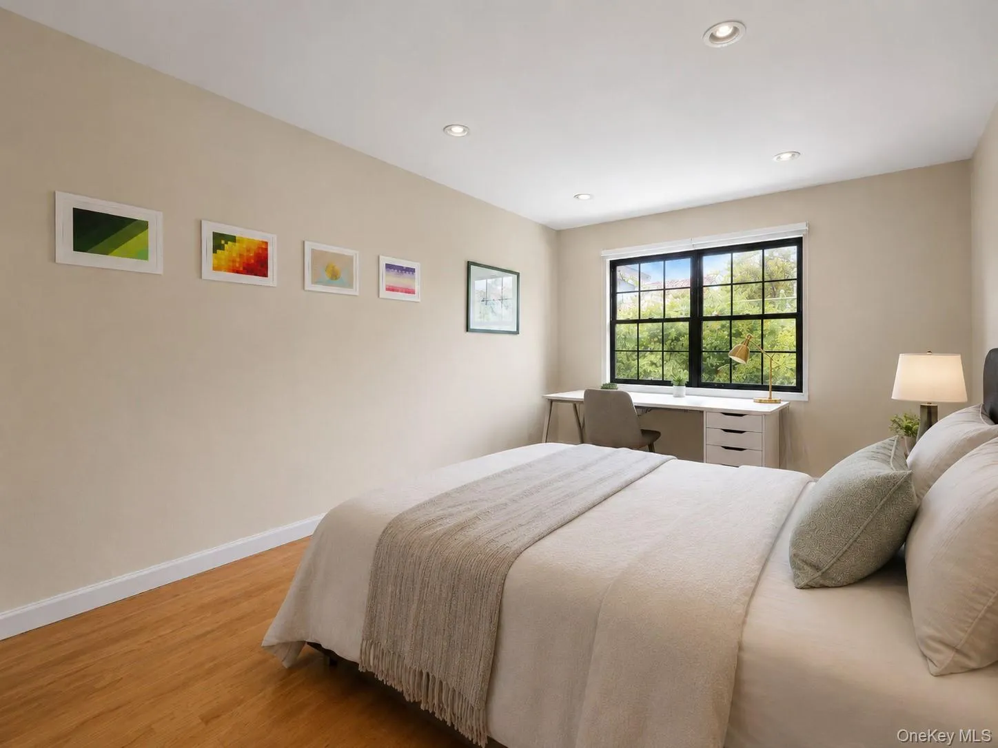 Recessed ceiling lighting, wood-finish flooring, light-toned wall paint, and a window with black framing Recessed ceiling lighting, wood-finish flooring, light-toned wall paint, and a window with black framing