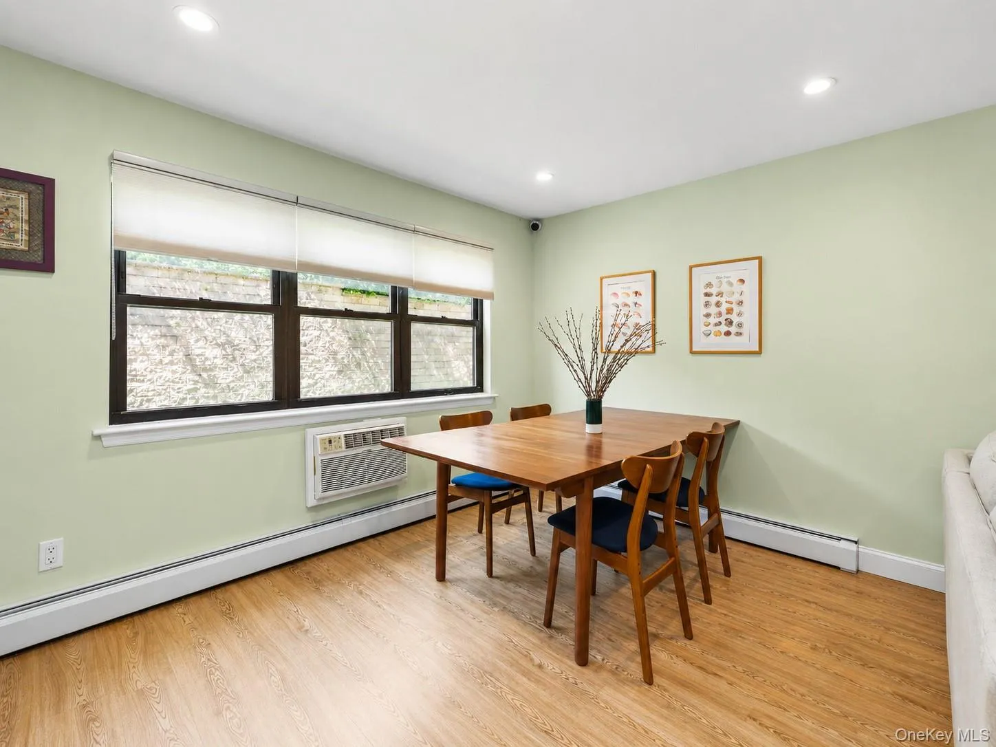 Recessed lighting, light wood-finish flooring, and a large multi-pane window Recessed lighting, light wood-finish flooring, and a large multi-pane window