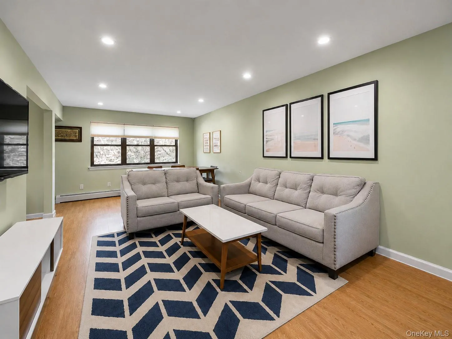 Recessed ceiling lighting, wood-finish flooring, multiple windows with roller shades, and light-toned wall finishes Recessed ceiling lighting, wood-finish flooring, multiple windows with roller shades, and light-toned wall finishes