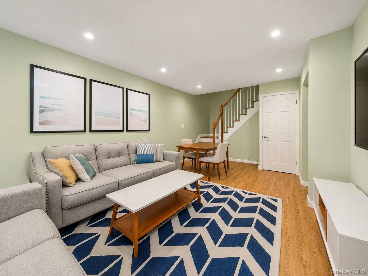 Recessed lighting illuminates the living space with wood-finish flooring Recessed lighting illuminates the living space with wood-finish flooring