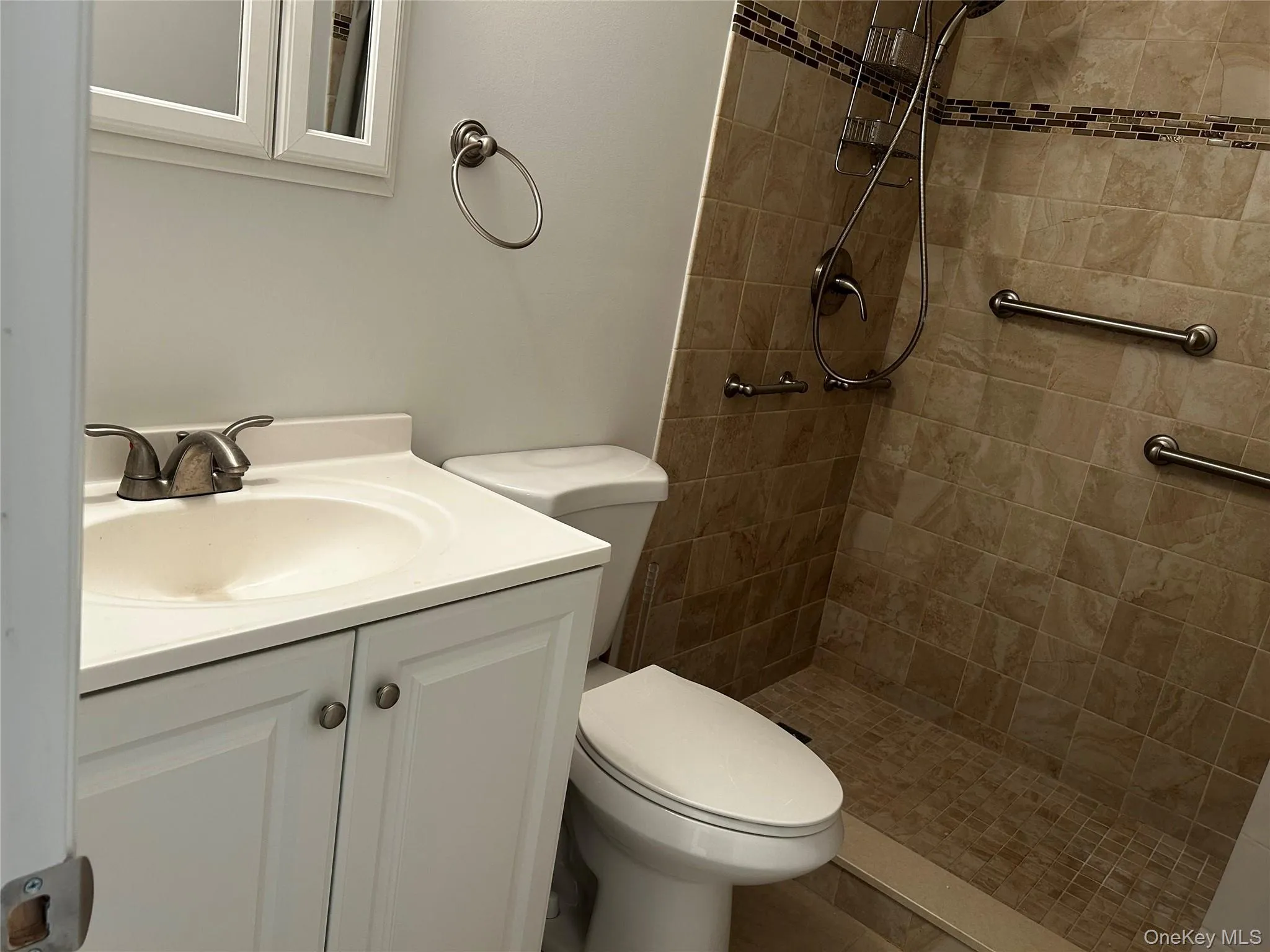 White vanity with integrated sink, brushed nickel faucet, and medicine cabinet White vanity with integrated sink, brushed nickel faucet, and medicine cabinet