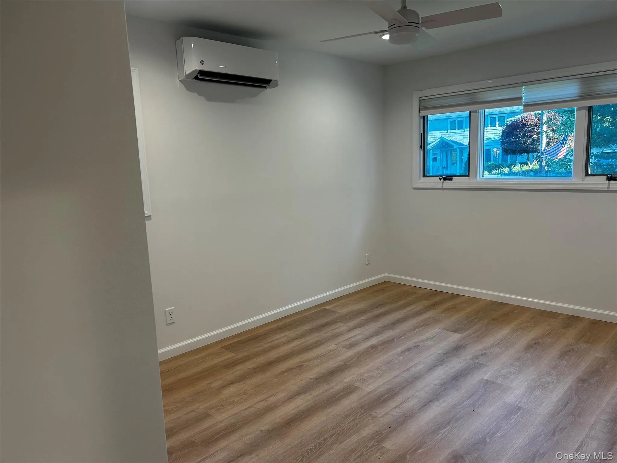 Luxury Vinyl flooring, ceiling fan, window with blinds, and ductless air conditioning unit Luxury Vinyl flooring, ceiling fan, window with blinds, and ductless air conditioning unit