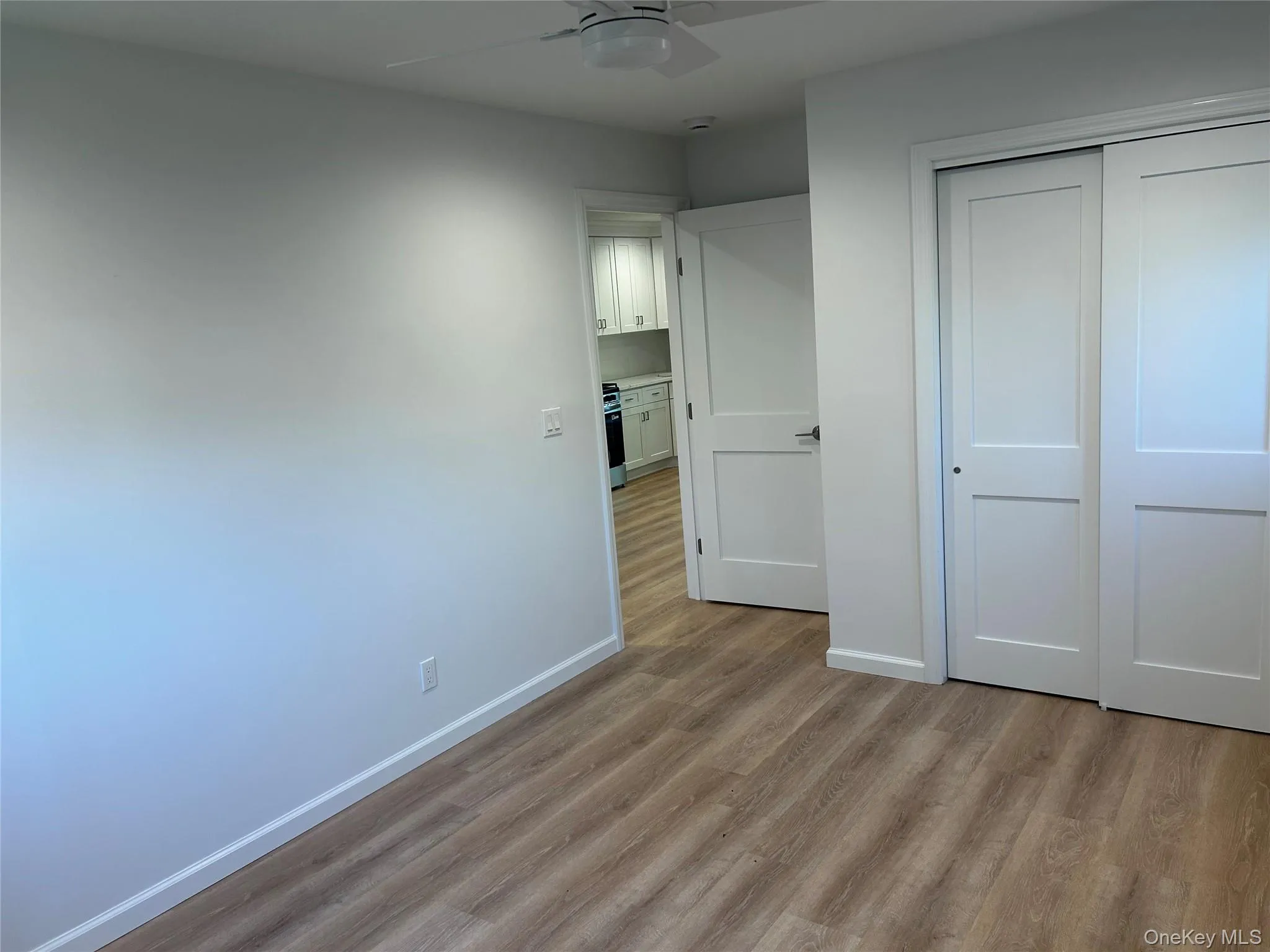Luxury Vinyl flooring, white walls, double closet and a ceiling fan Luxury Vinyl flooring, white walls, double closet and a ceiling fan