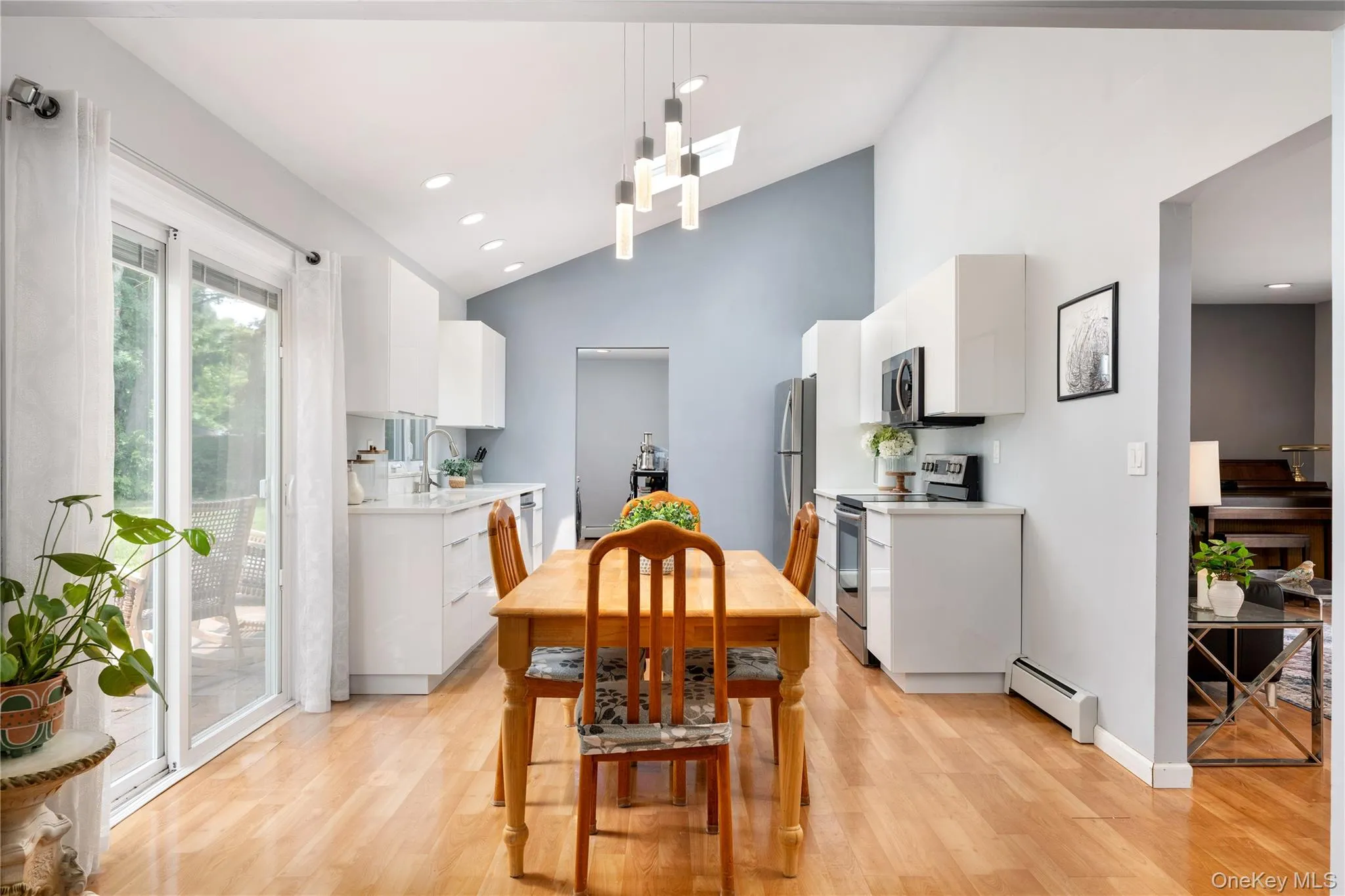 Eat in kitchen with vaulted ceilings, skylight, overhead light, sliding door to patio Eat in kitchen with vaulted ceilings, skylight, overhead light, sliding door to patio