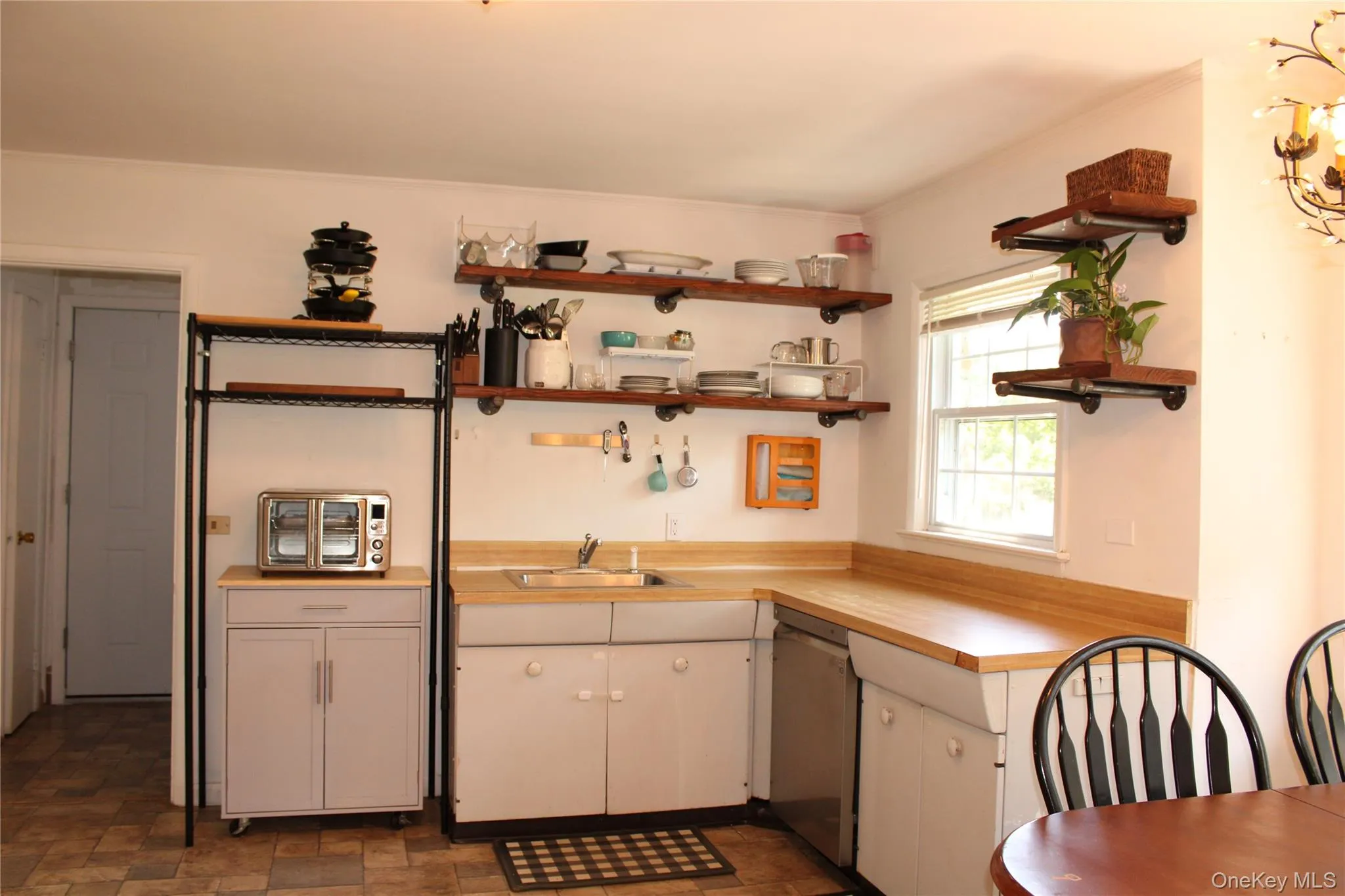 Spacious kitchen with stainless steel dishwasher and laminate countertops Spacious kitchen with stainless steel dishwasher and laminate countertops