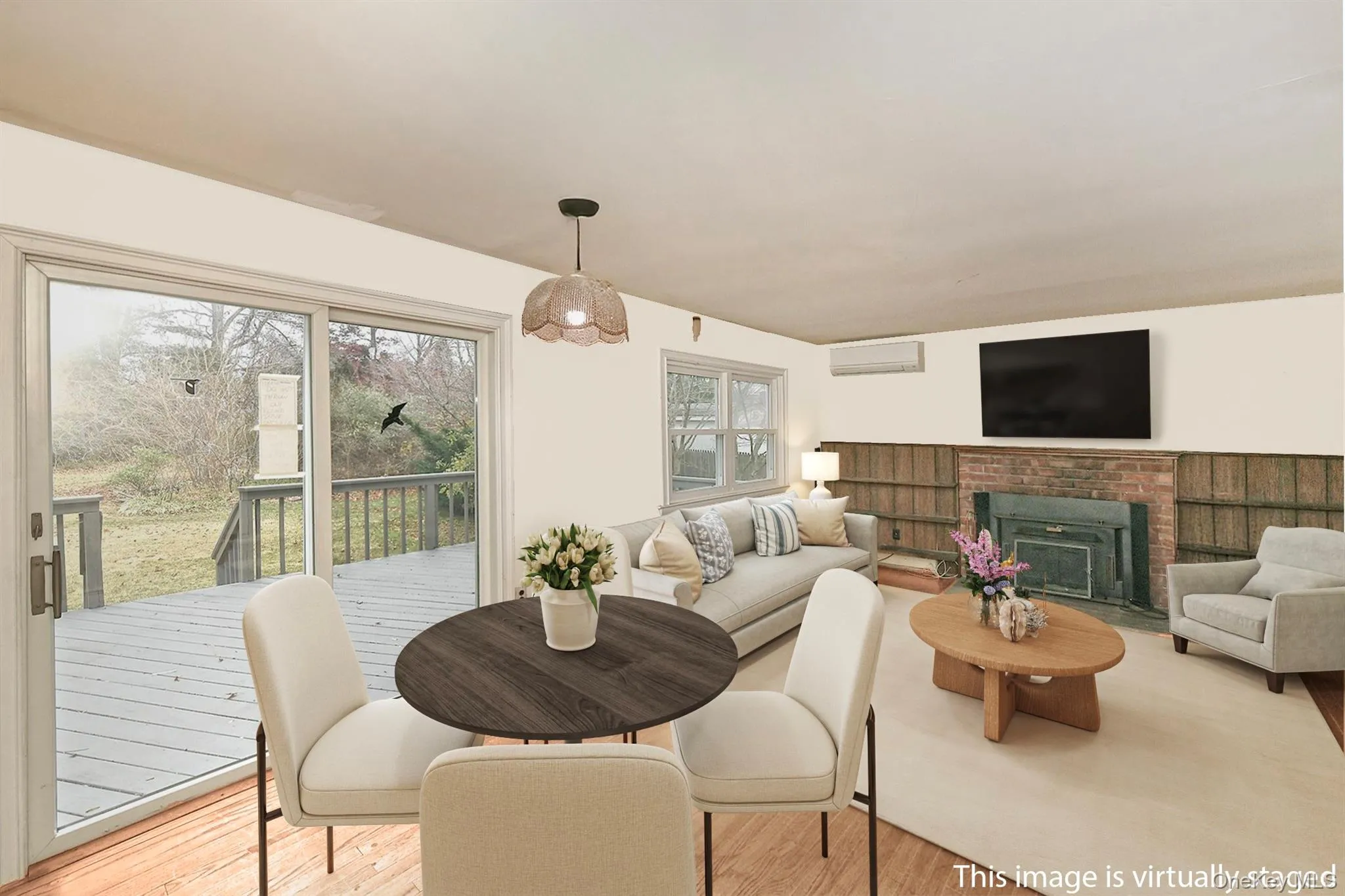 Family room with fireplace and eating area virtually staged Family room with fireplace and eating area virtually staged