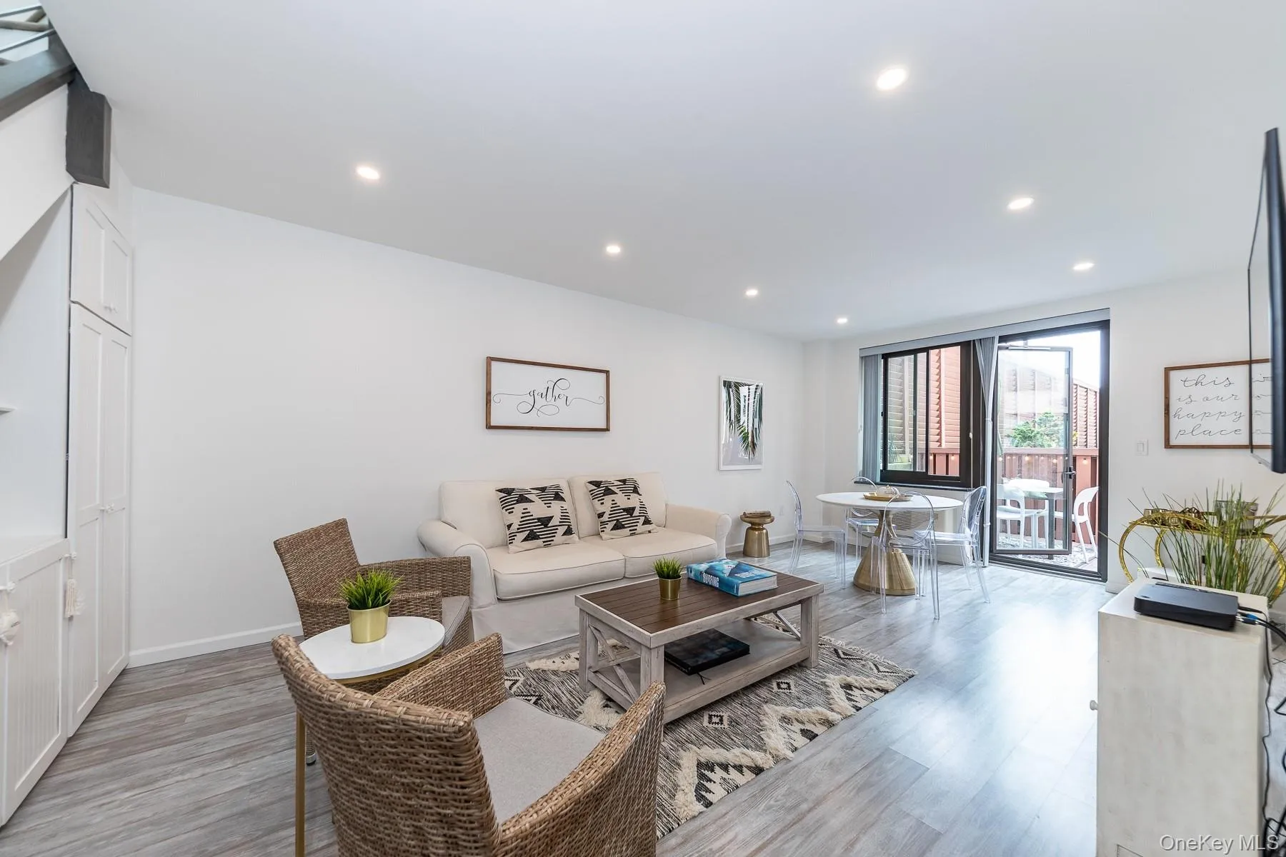 Open living room with sliding glass doors to deck Open living room with sliding glass doors to deck