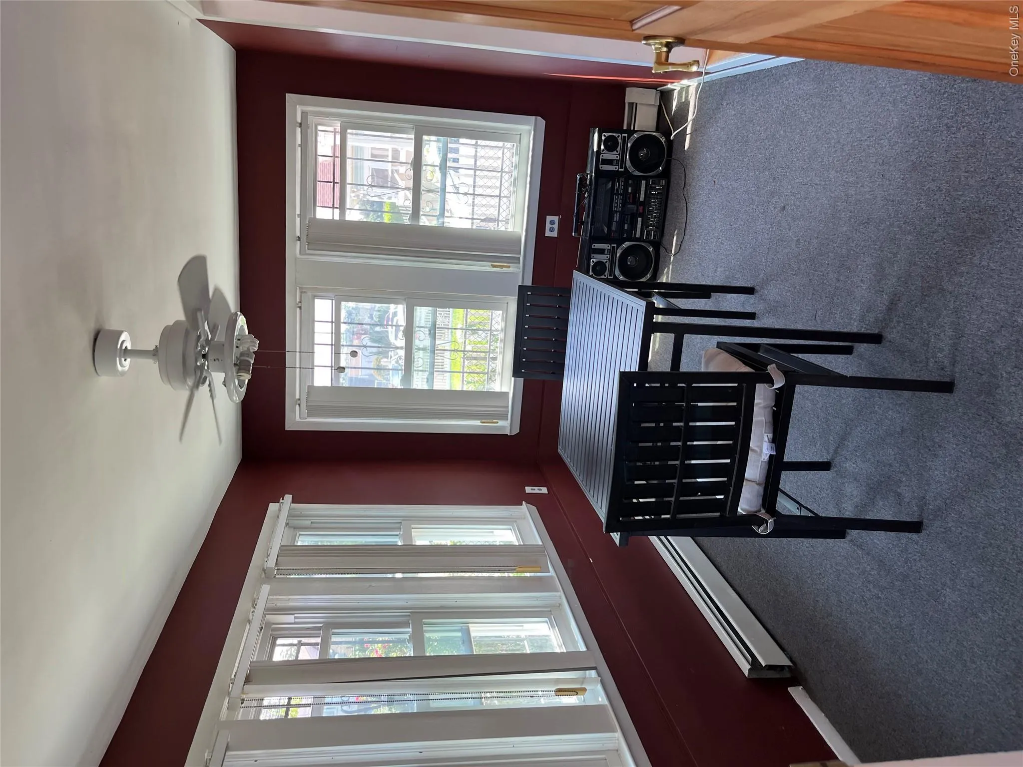 Multiple windows, ceiling fan, and carpet flooring Multiple windows, ceiling fan, and carpet flooring