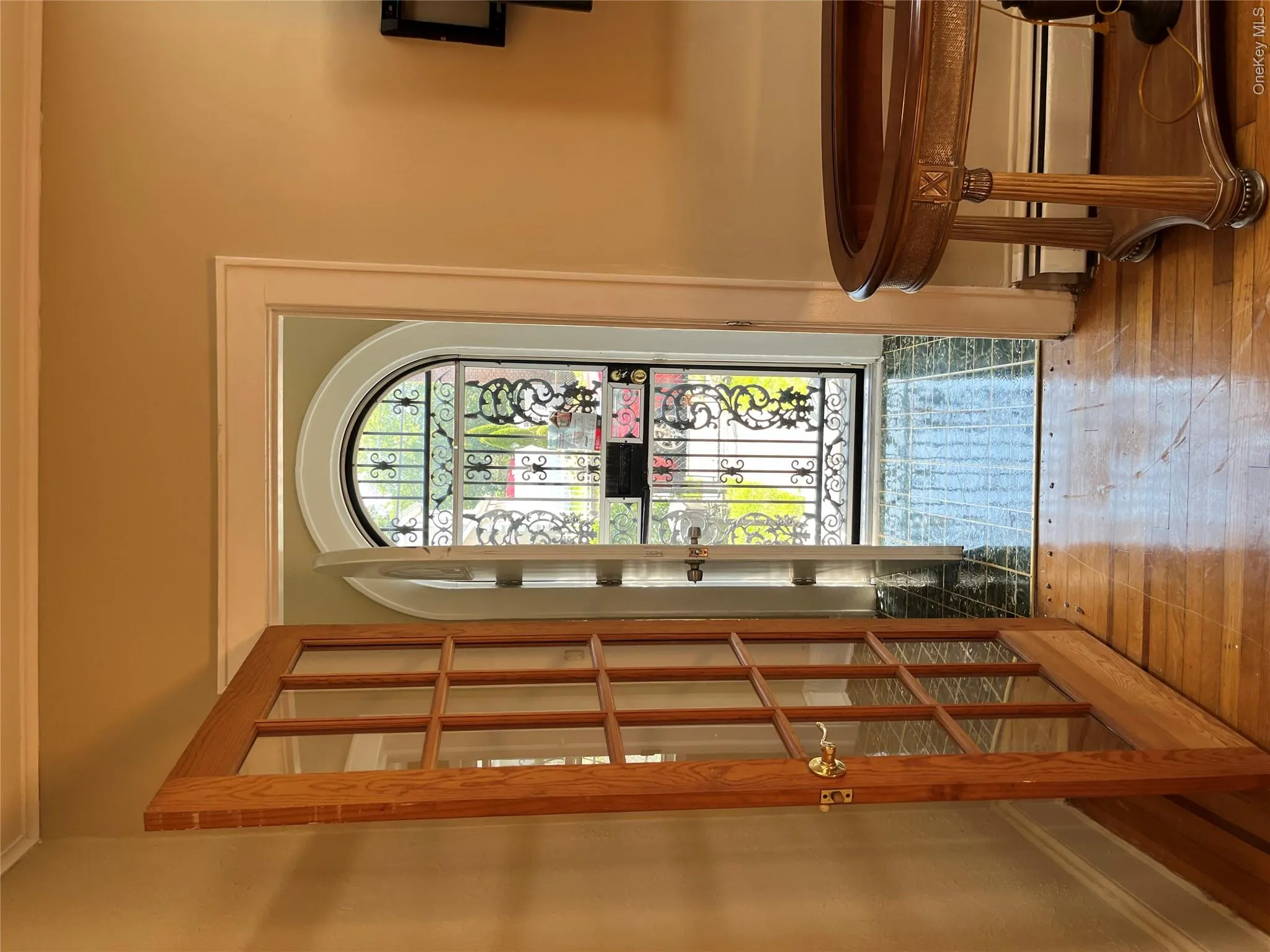 Hardwood flooring, French doors with glass panes, arched doorway, wrought iron security door, and crown molding Hardwood flooring, French doors with glass panes, arched doorway, wrought iron security door, and crown molding