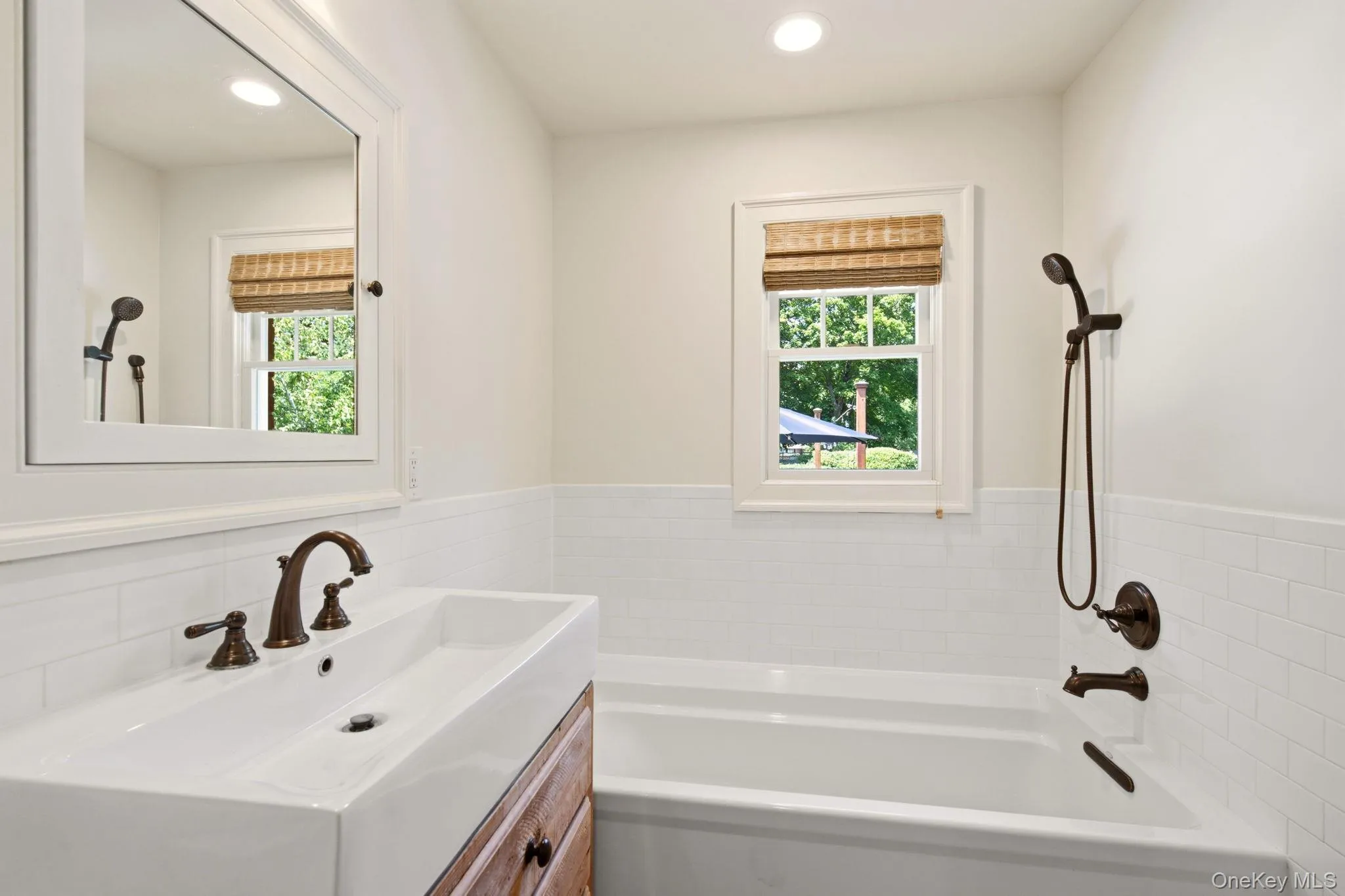 Soaking tub and window offering natural light. Soaking tub and window offering natural light.