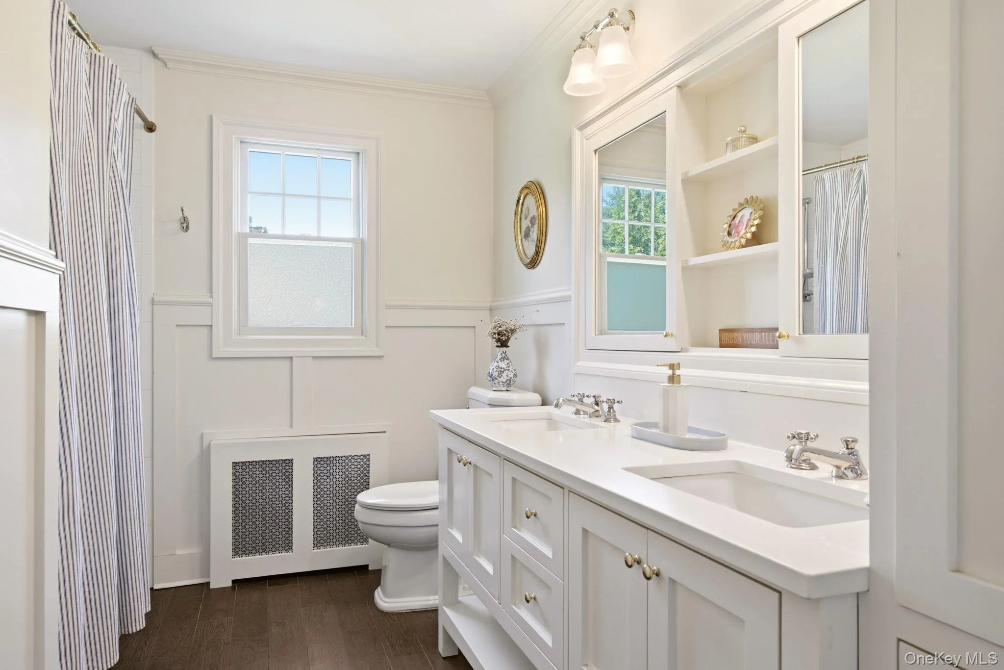 Gorgeous Hallway Bathroom with double vanity, built in shelving, wainscotting and tub. Gorgeous Hallway Bathroom with double vanity, built in shelving, wainscotting and tub.