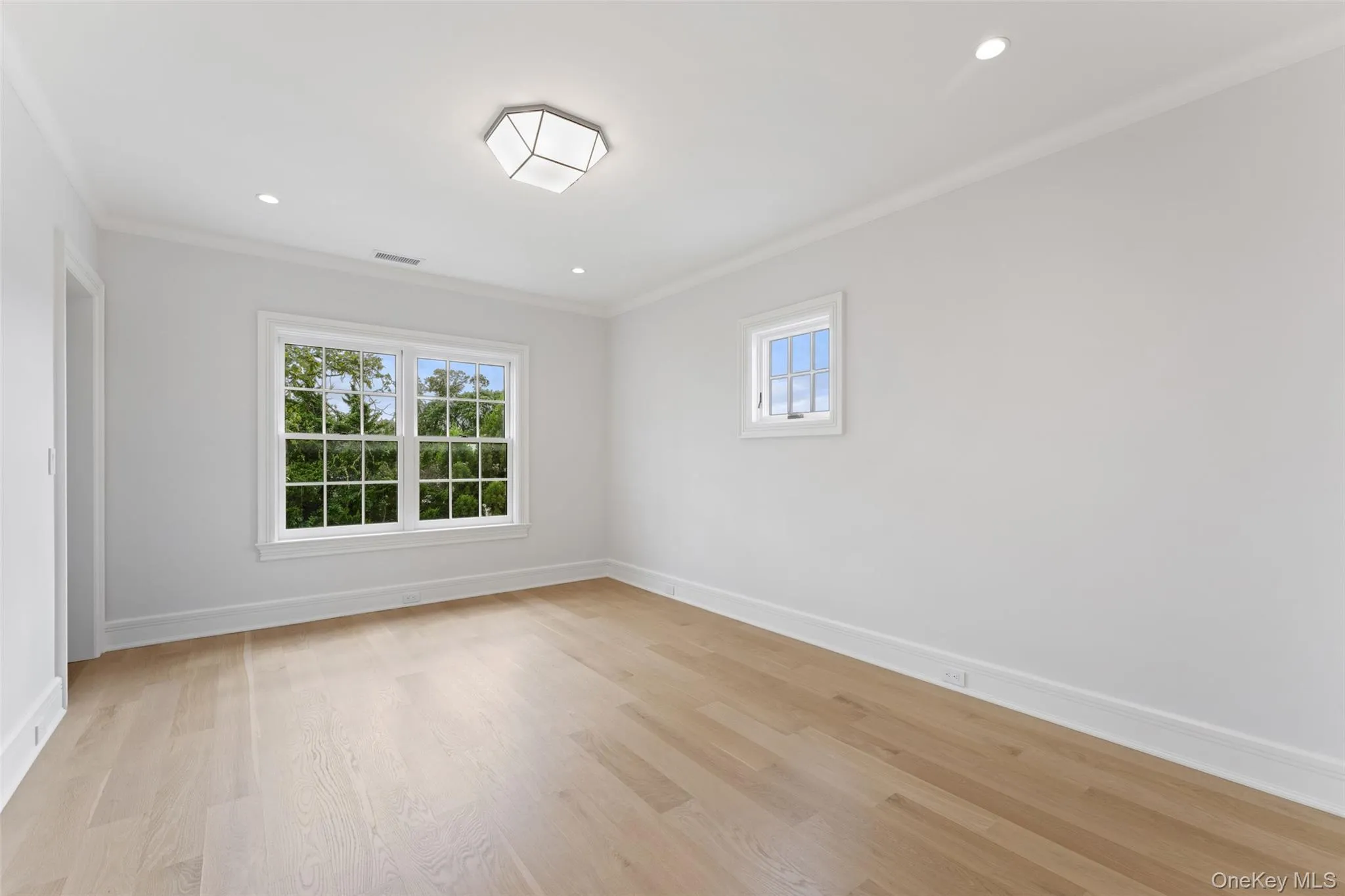 Bright ensuite bedroom with white oak floors. Bright ensuite bedroom with white oak floors.