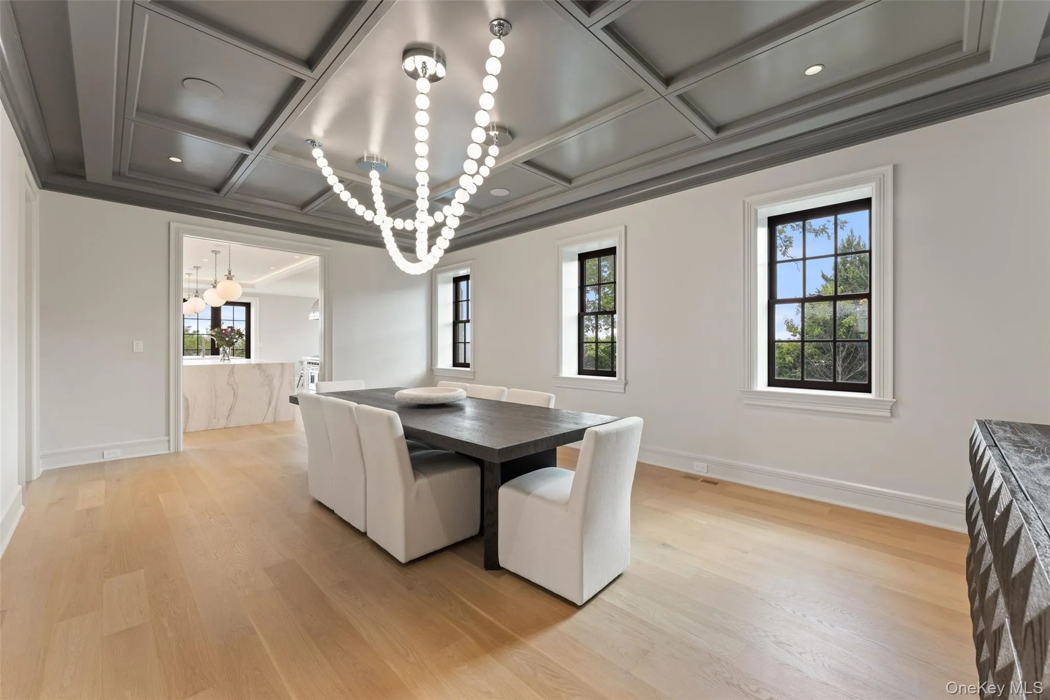 Elegant formal dining room distinguished by its richly detailed coffered ceiling. Elegant formal dining room distinguished by its richly detailed coffered ceiling.
