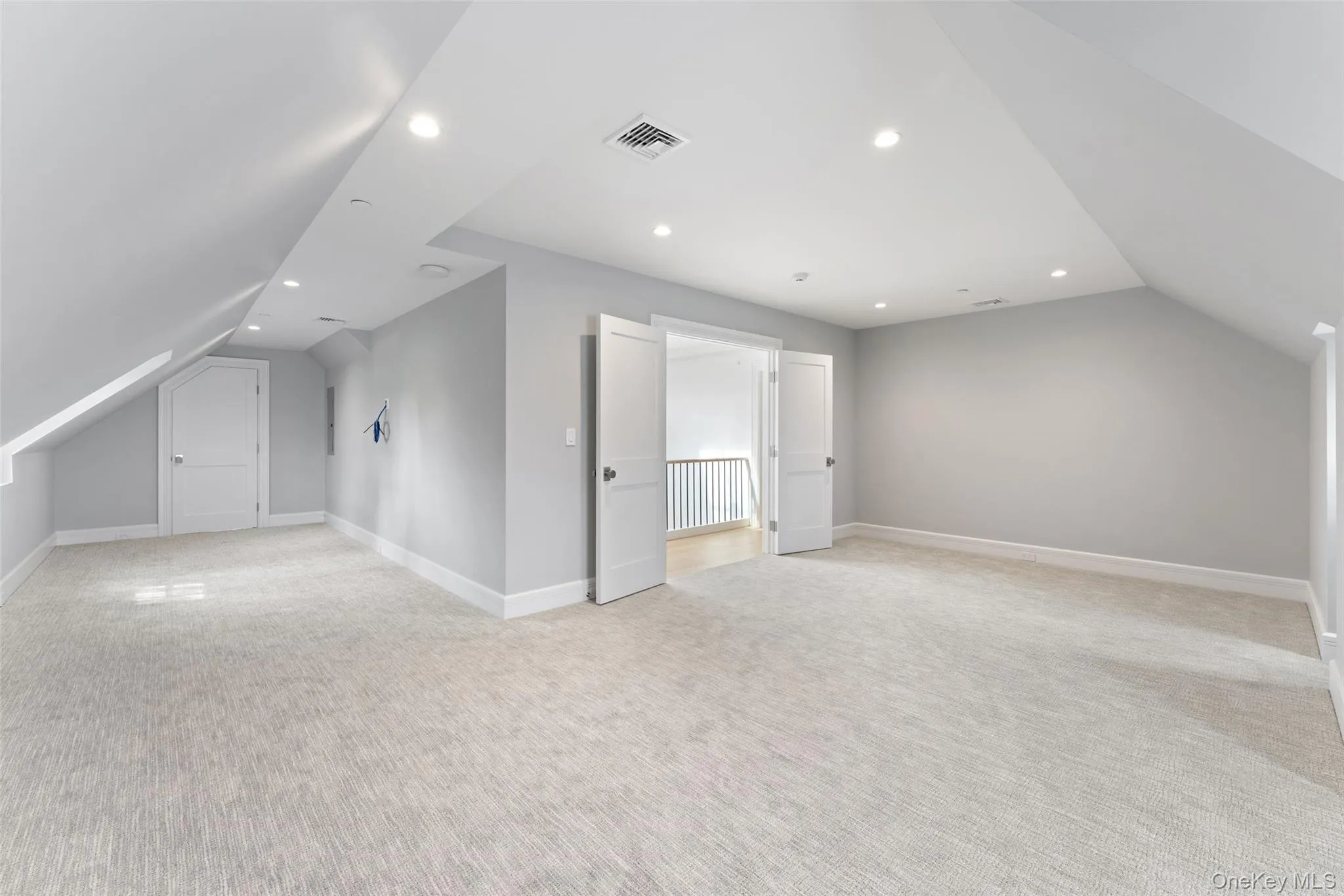 Spacious upper-level bonus room with water views, vaulted ceiling and soft carpeting. Spacious upper-level bonus room with water views, vaulted ceiling and soft carpeting.