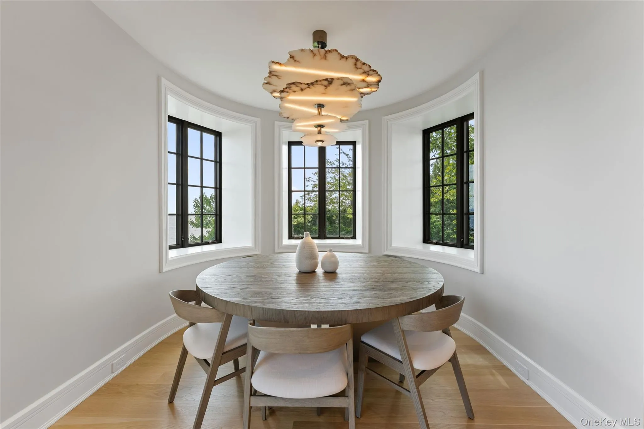 Sunlit breakfast bay framed by windows, and peaceful water and garden views. Sunlit breakfast bay framed by windows, and peaceful water and garden views.