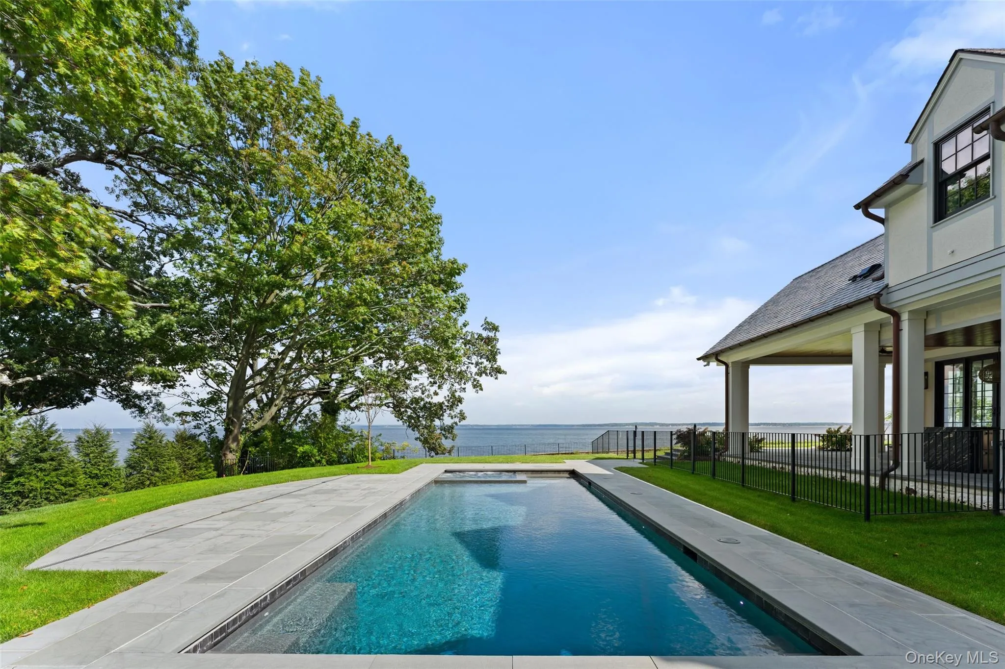 The waterfront pool and spa capture expansive views of Long Island Sound. The waterfront pool and spa capture expansive views of Long Island Sound.