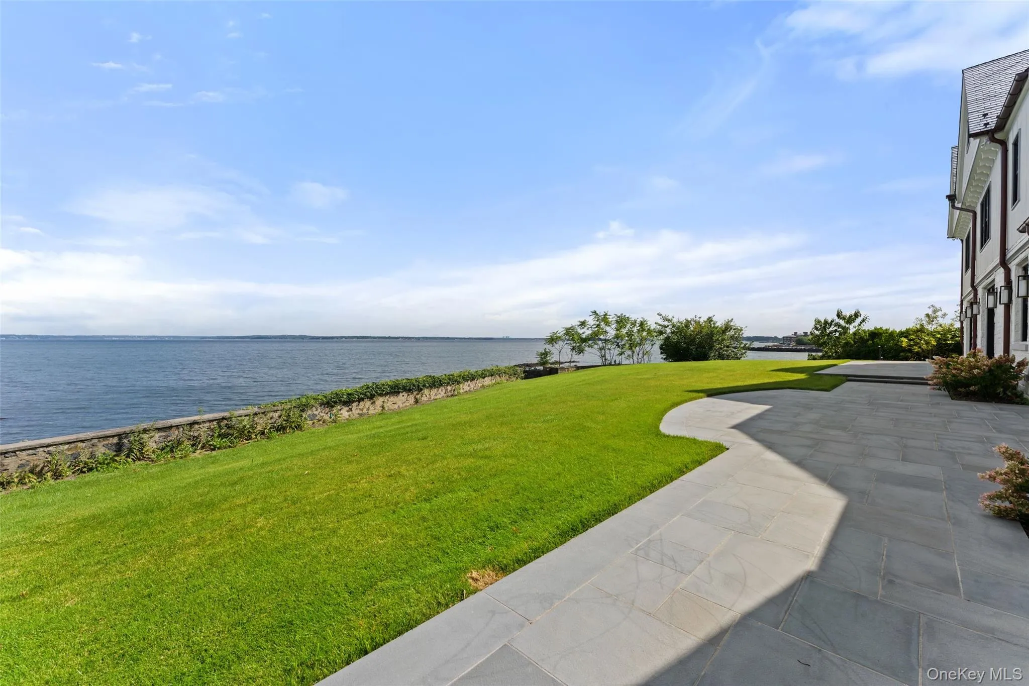 The first floor provides ample access to a bluestone terrace and manicured lawn open to panoramic Long Island Sound views. The first floor provides ample access to a bluestone terrace and manicured lawn open to panoramic Long Island Sound views.