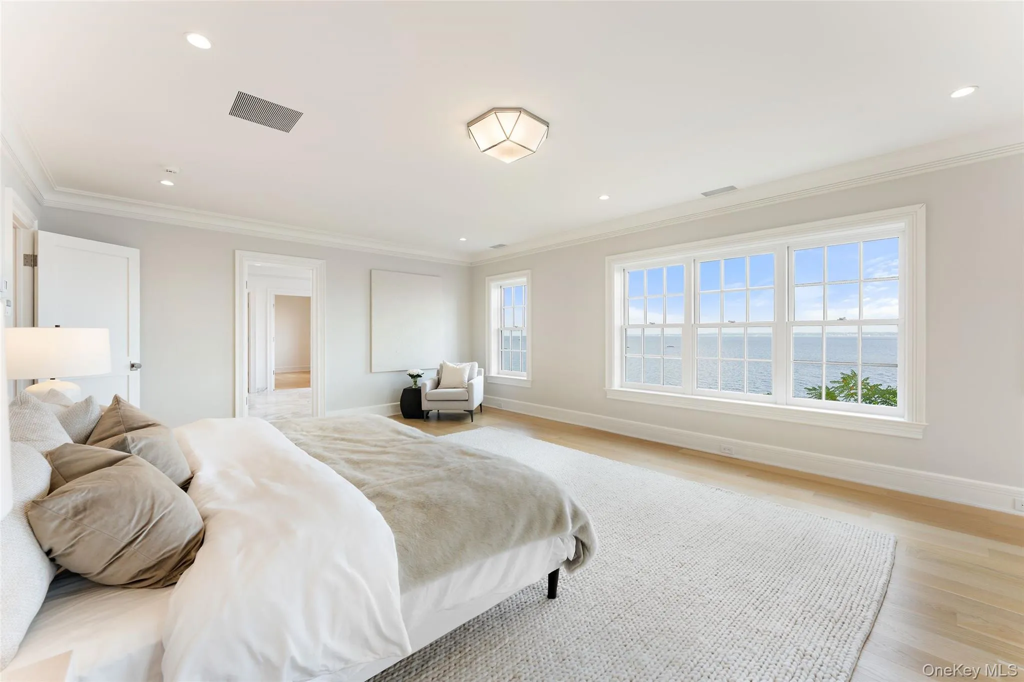 The primary suite offers sweeping water views and ample space for a private sitting area. The primary suite offers sweeping water views and ample space for a private sitting area.