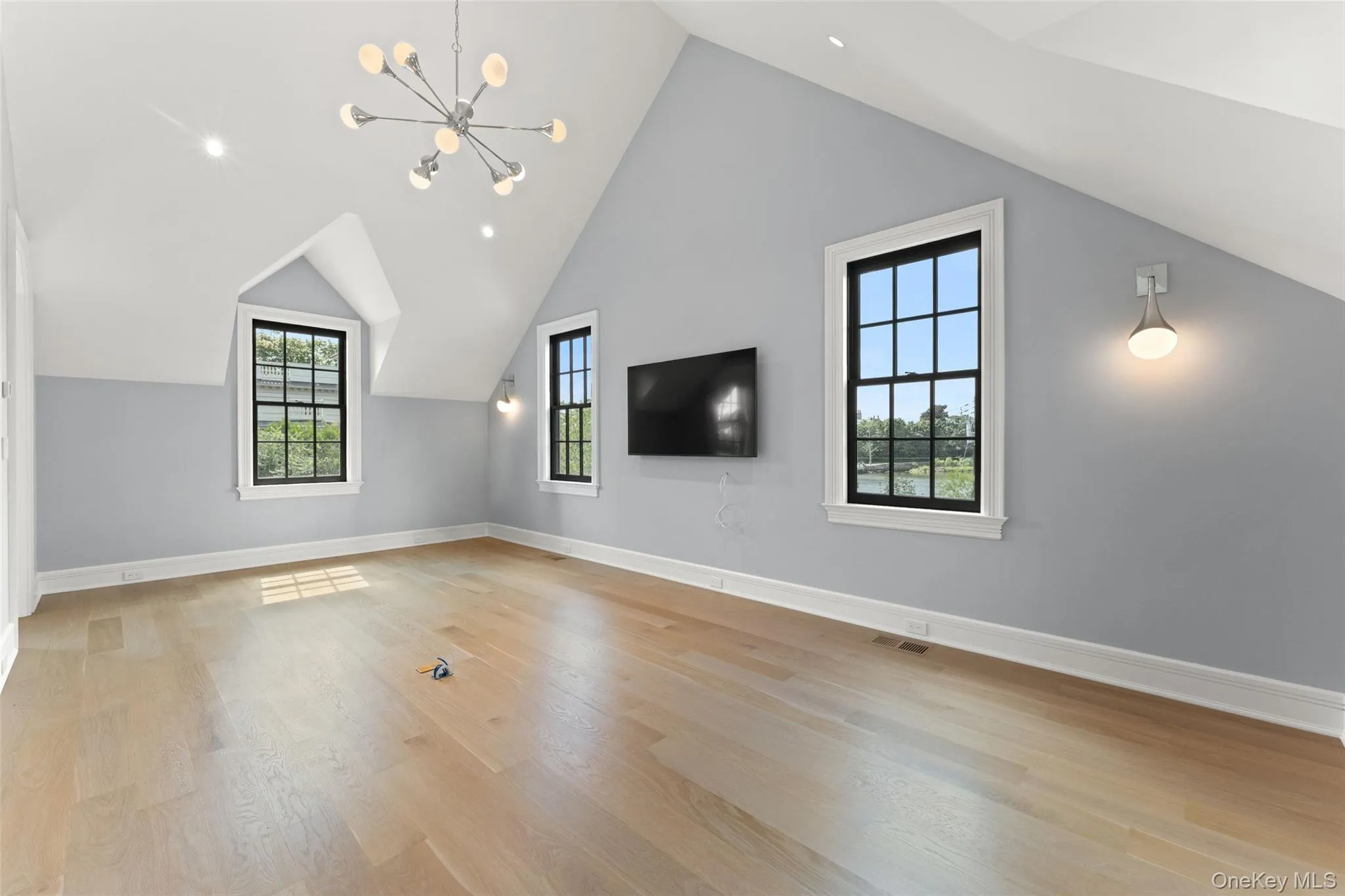 A private, light-filled room perfect for a home office or media retreat with soaring vaulted ceilings, custom architectural detail, and serene water views, an inspiring setting for working, relaxing, or unwinding in style. A private, light-filled room perfect for a home office or media retreat with soaring vaulted ceilings, custom architectural detail, and serene water views, an inspiring setting for working, relaxing, or unwinding in style.