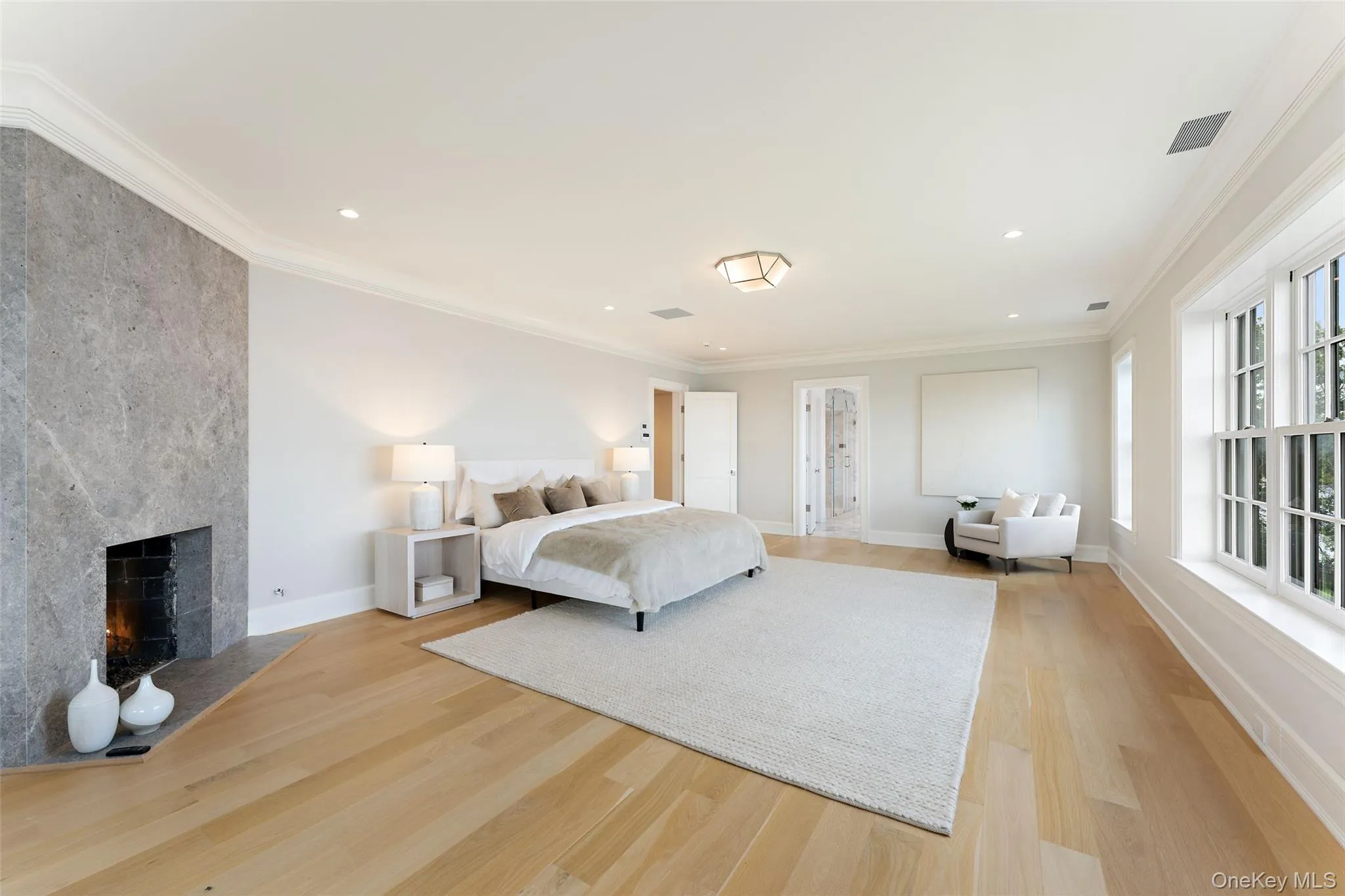 The spacious primary suite features a stone-clad gas fireplace and direct access to the spa bath. The spacious primary suite features a stone-clad gas fireplace and direct access to the spa bath.