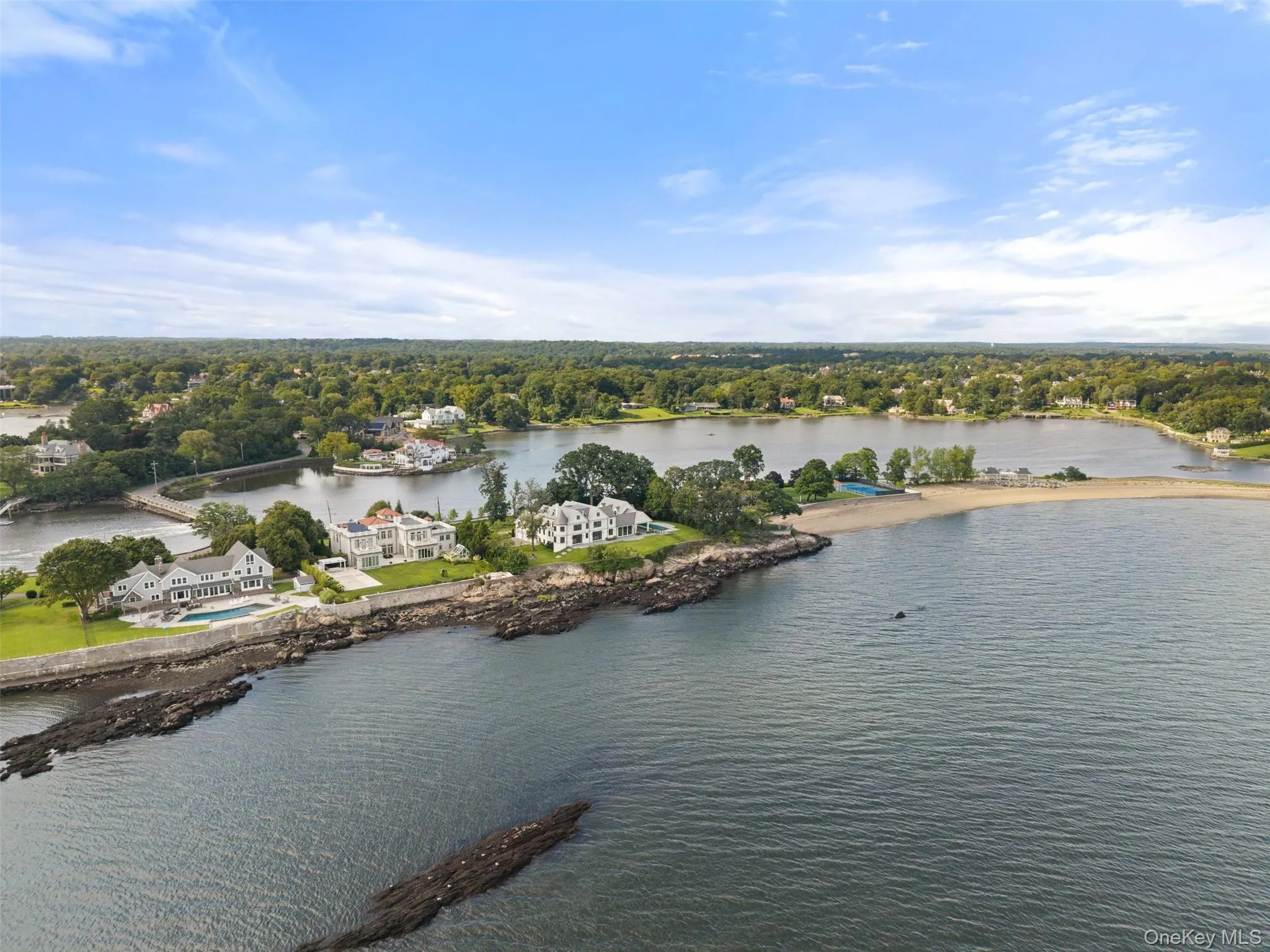 An aerial perspective reveals the property's extraordinary position between Long Island Sound and Premium Mill Pond - an irreplaceable setting of remarkable beauty and privacy, with deeded beach access and exclusive boat slips included. An aerial perspective reveals the property's extraordinary position between Long Island Sound and Premium Mill Pond - an irreplaceable setting of remarkable beauty and privacy, with deeded beach access and exclusive boat slips included.