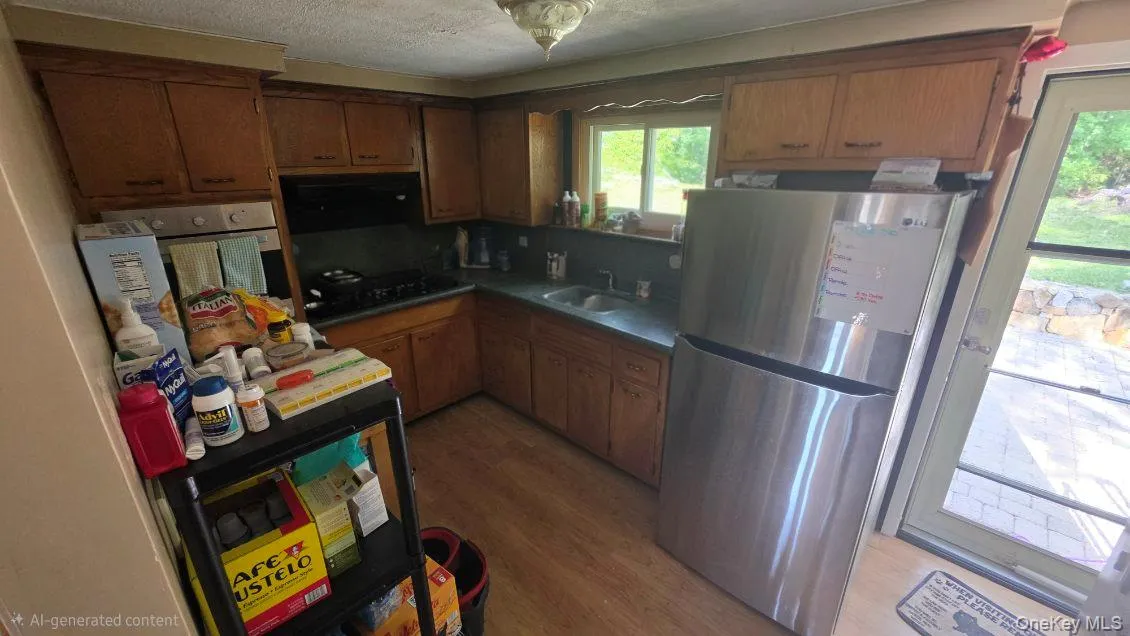 Kitchen featuring wood-finish cabinetry, built-in stainless steel appliances, and a double basin sink Kitchen featuring wood-finish cabinetry, built-in stainless steel appliances, and a double basin sink