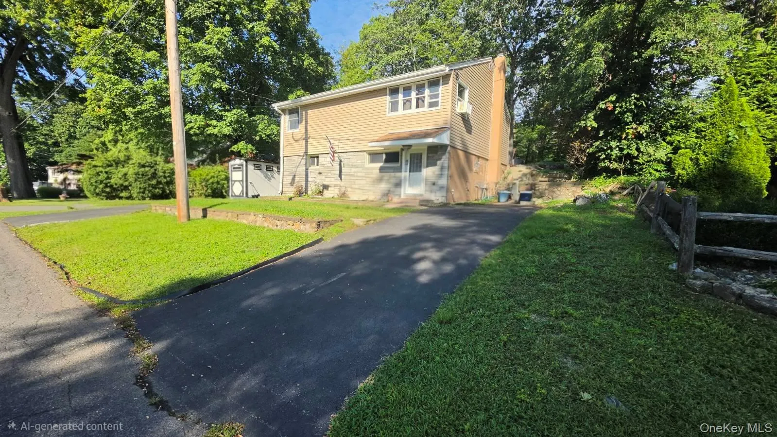 Siding exterior with stone foundation and paved driveway Siding exterior with stone foundation and paved driveway