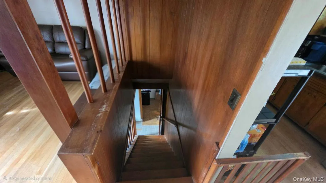 Wood-paneled wall, wood staircase with balusters, and wood-finish flooring Wood-paneled wall, wood staircase with balusters, and wood-finish flooring