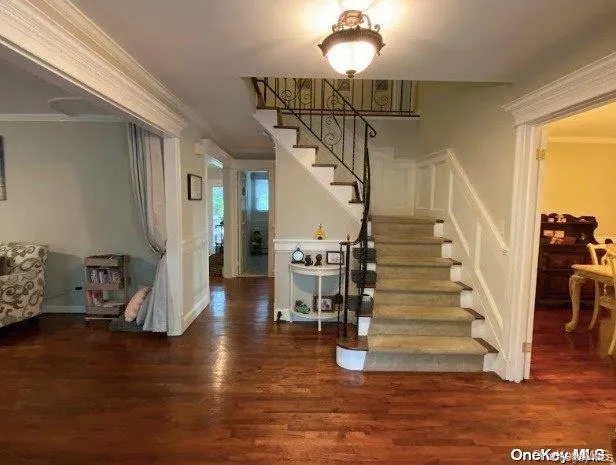 Stairs with crown molding and wood finished floors Stairs with crown molding and wood finished floors