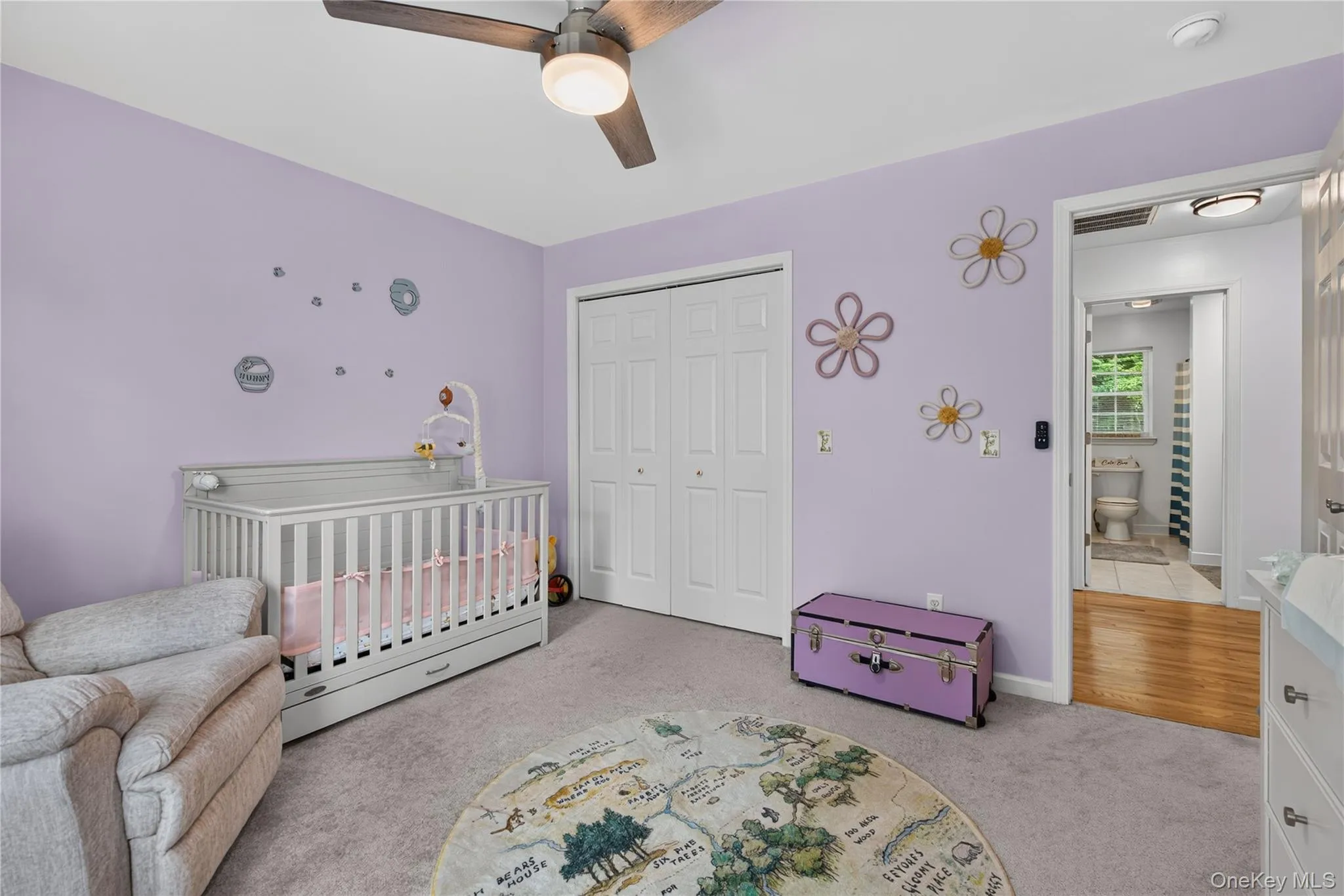 Carpeted flooring, ceiling fan, white bi-fold closet doors, and light purple wall color Carpeted flooring, ceiling fan, white bi-fold closet doors, and light purple wall color