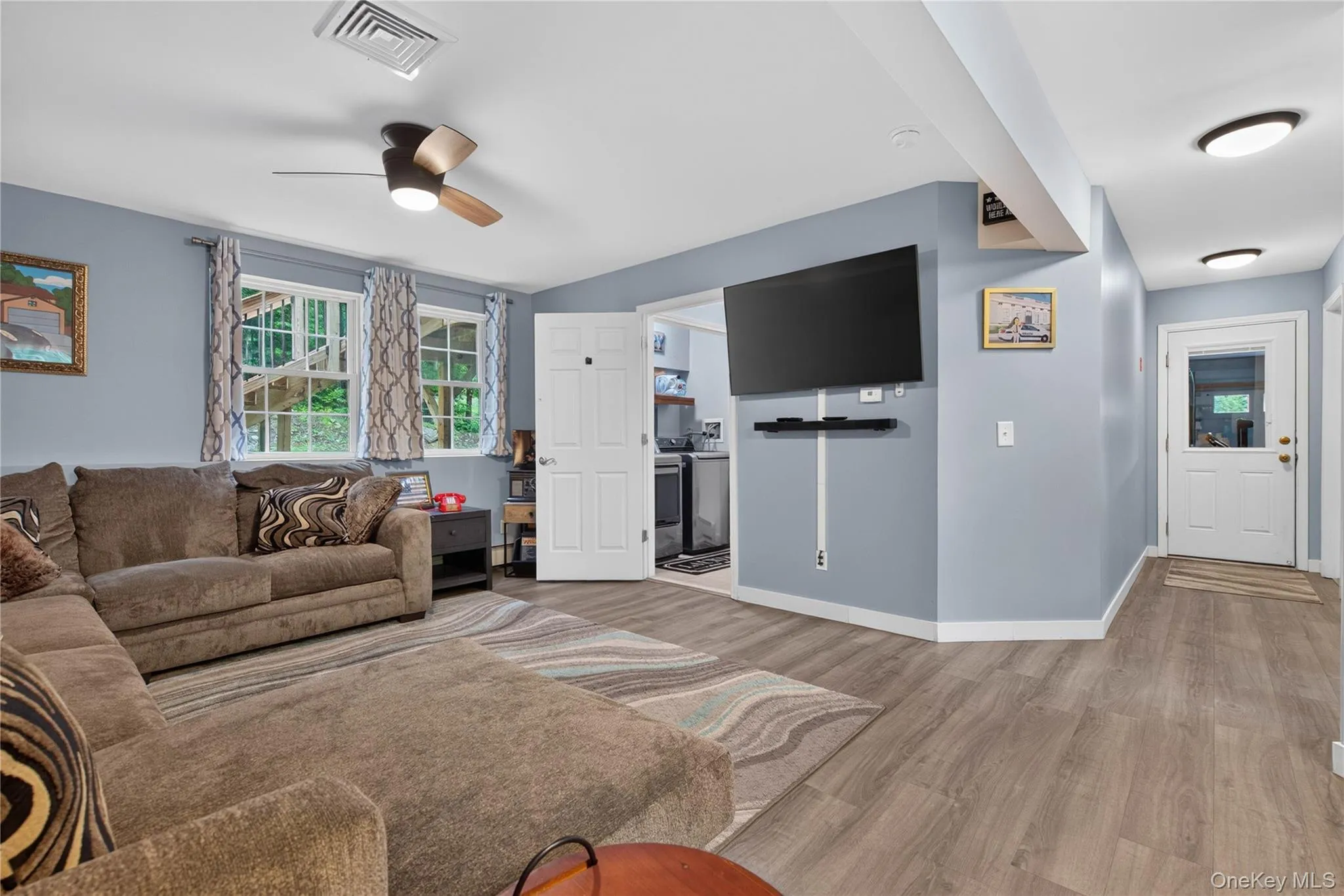 Wood-finish flooring throughout, ceiling fan with integrated lighting, recessed lighting, and white paneled doors Wood-finish flooring throughout, ceiling fan with integrated lighting, recessed lighting, and white paneled doors