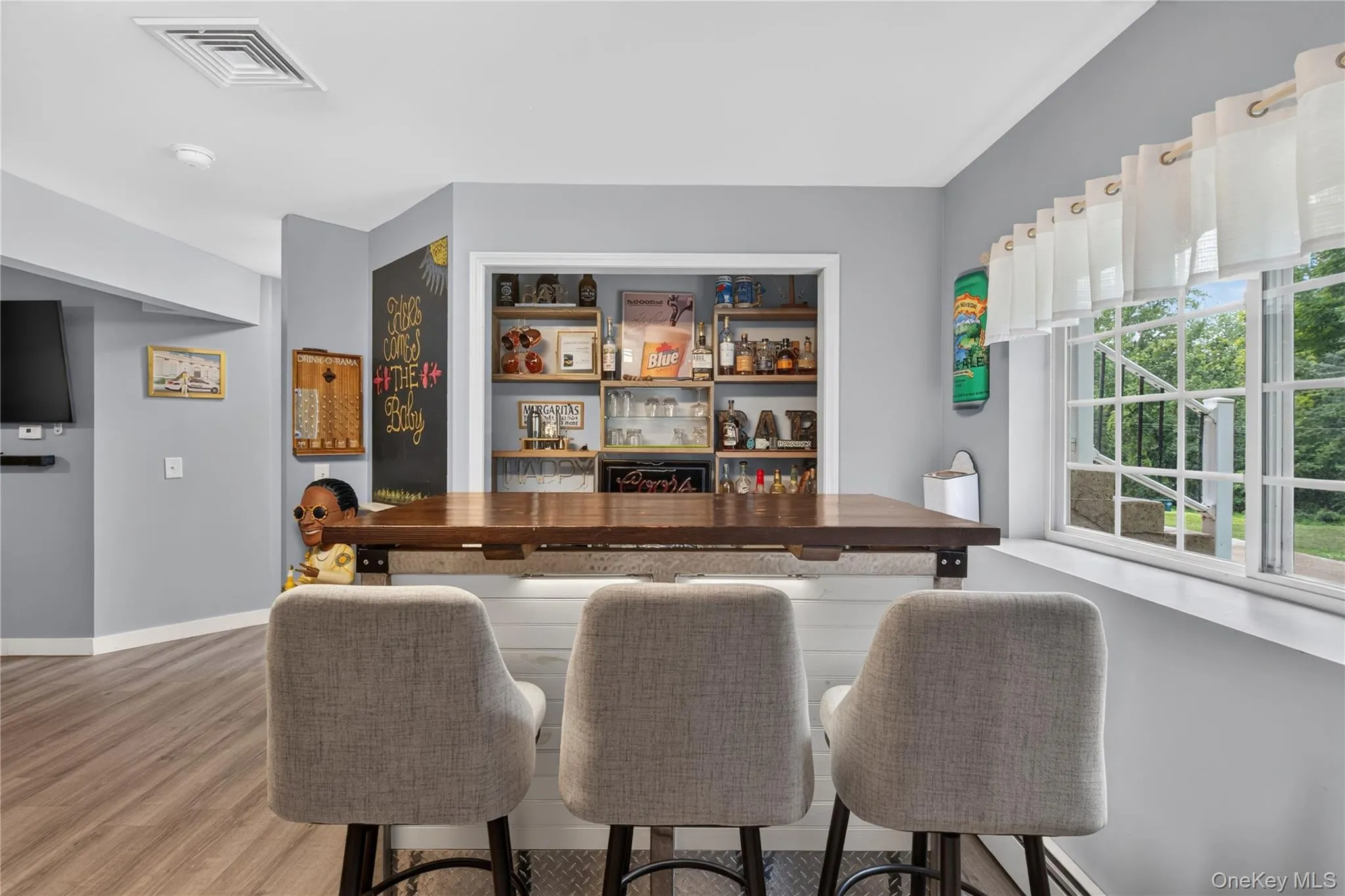Built-in bar with wood countertop and open shelving Built-in bar with wood countertop and open shelving